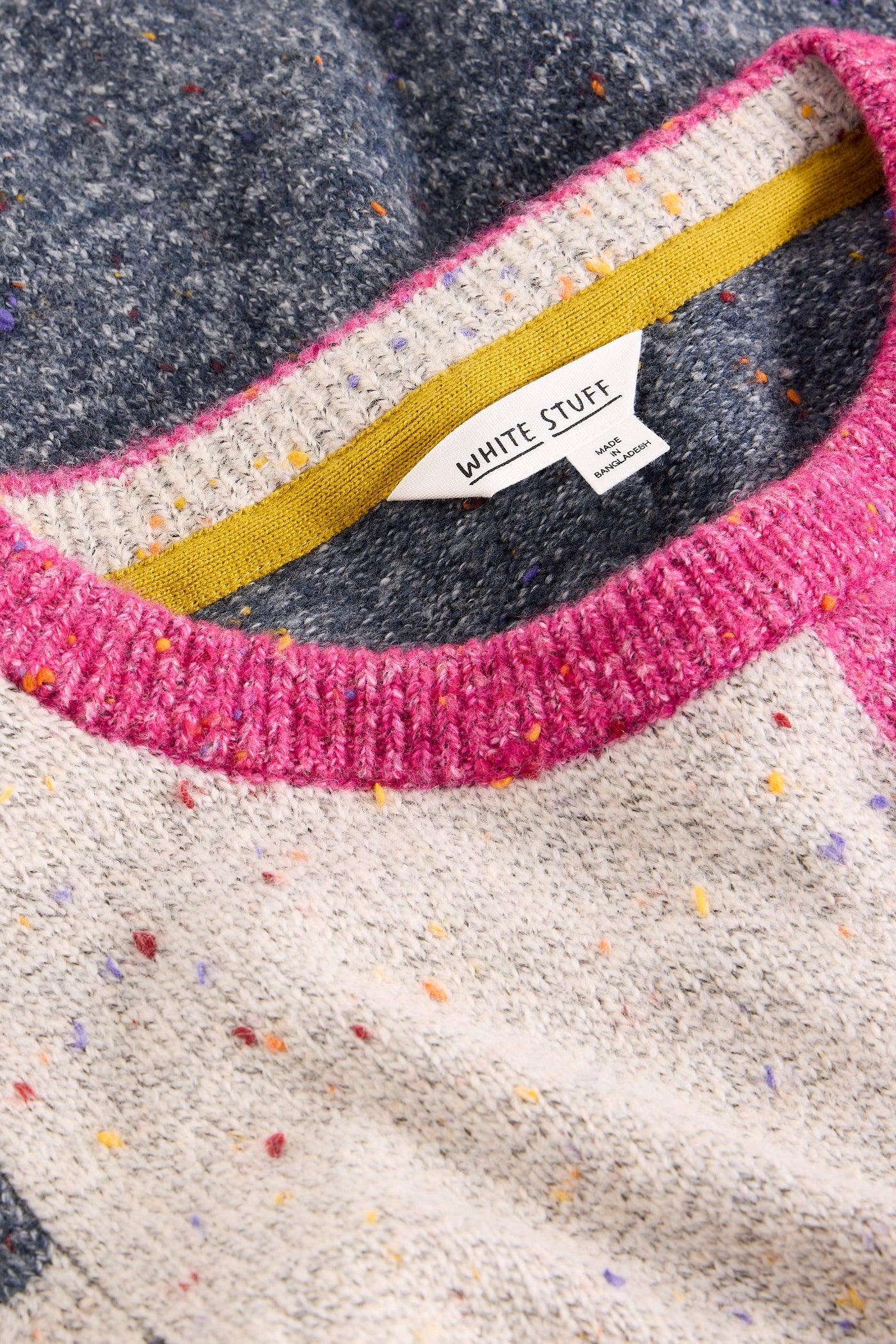 Close up of pink crew neck collar on organic cotton knit jumper
