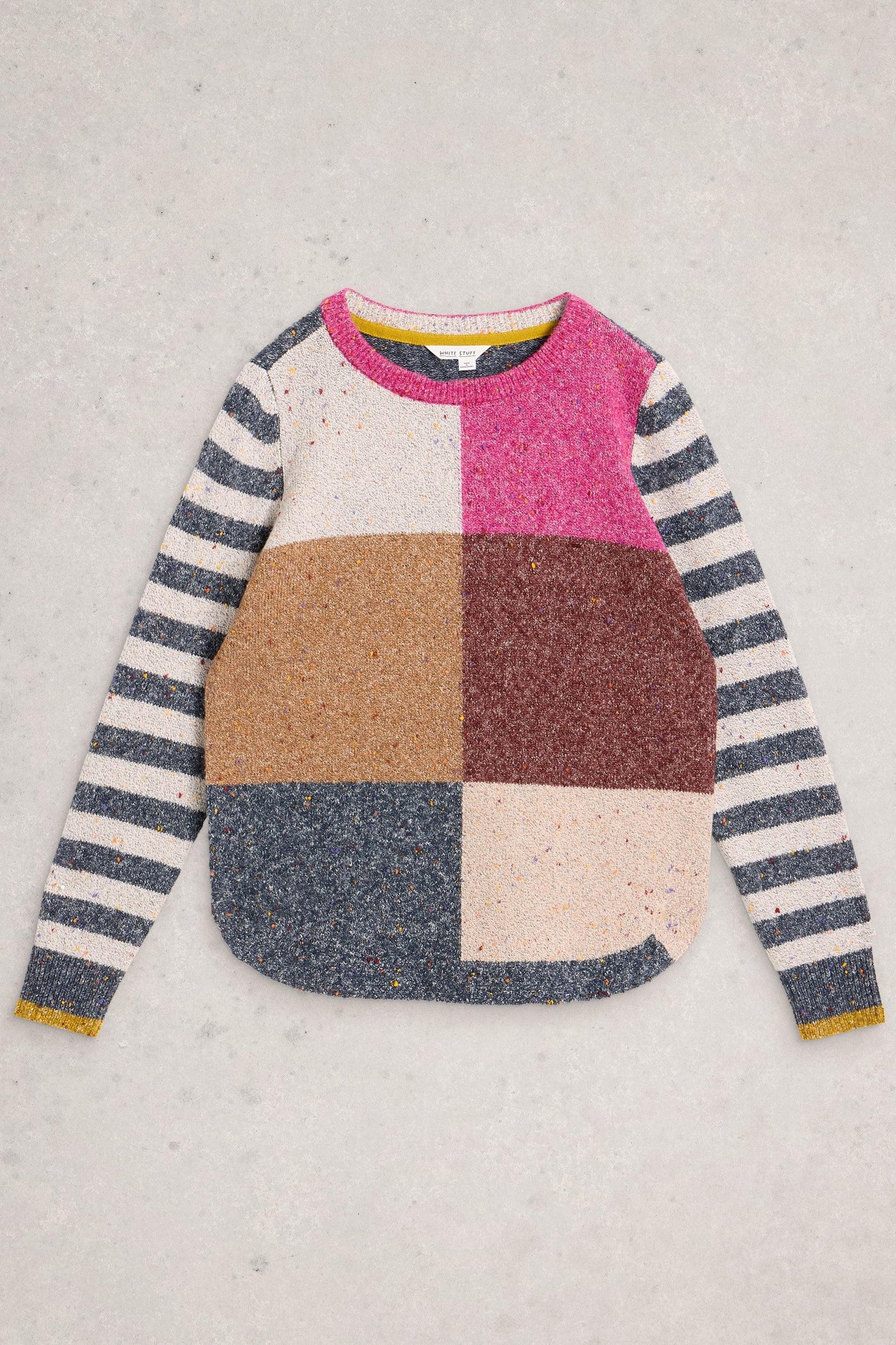 Multicolour organic cotton knit jumper laid flat on neutral background