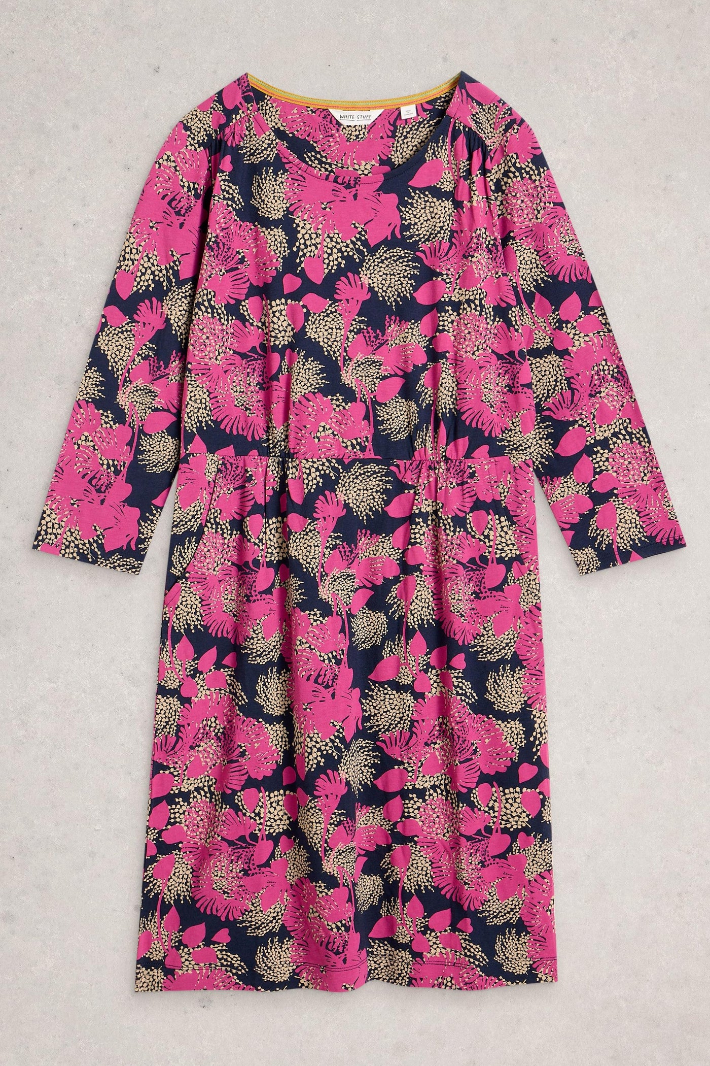 Knee-length organic cotton dress in pink floral print, folded flat on a neutral background