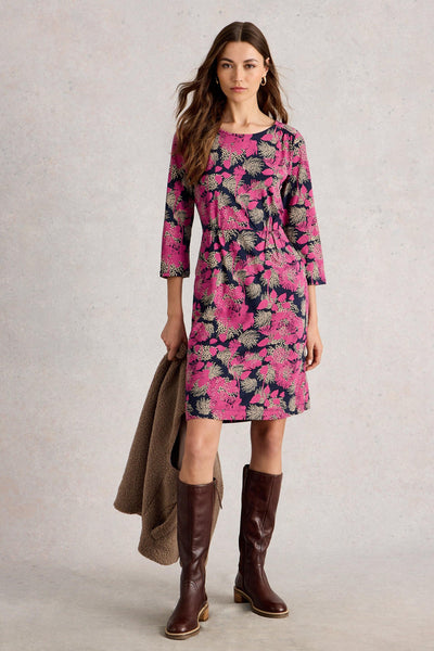 Organic cotton jersey dress with pink and cream floral print, gathered waist and side pockets styled with brown knee-high boots