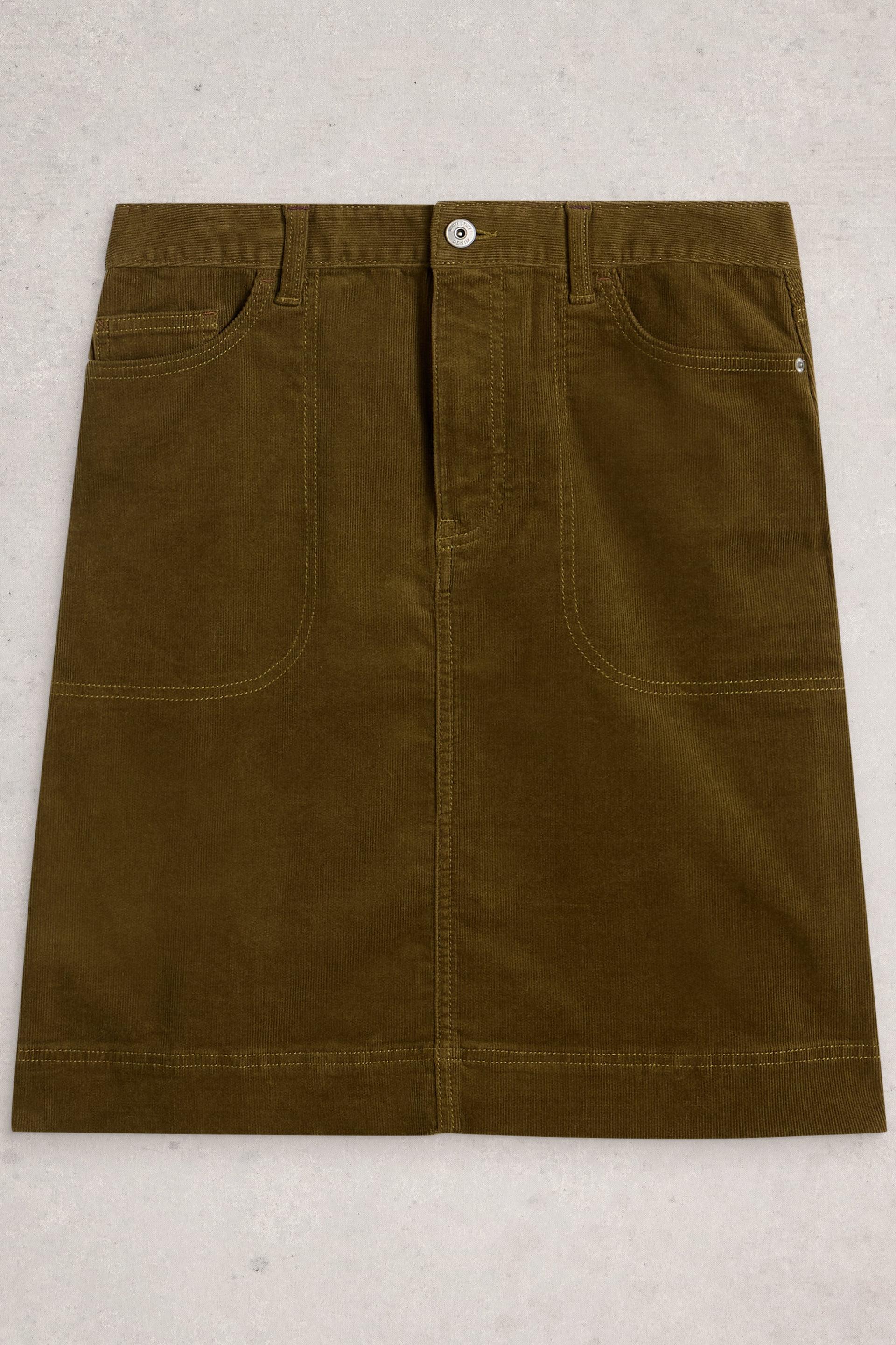 Green organic cotton skirt on a light gray background