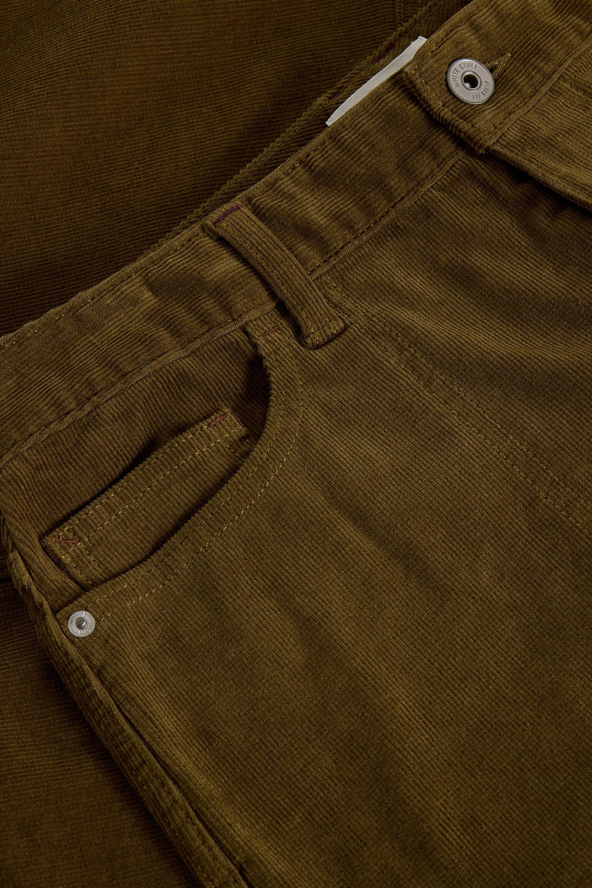 Close-up of green skirt with button details