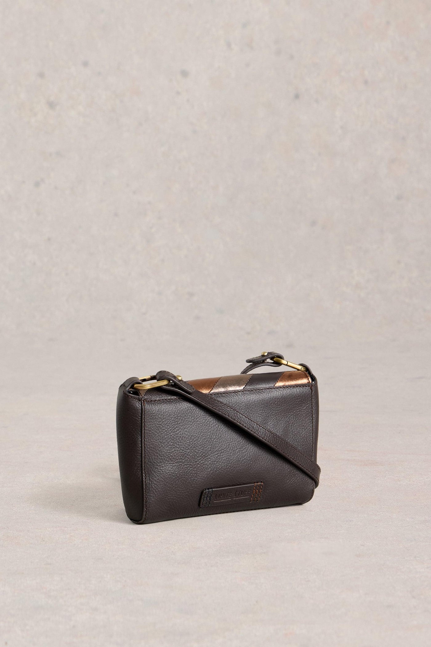 Black leather handbag on a light gray background