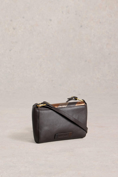Black leather handbag on a light gray background