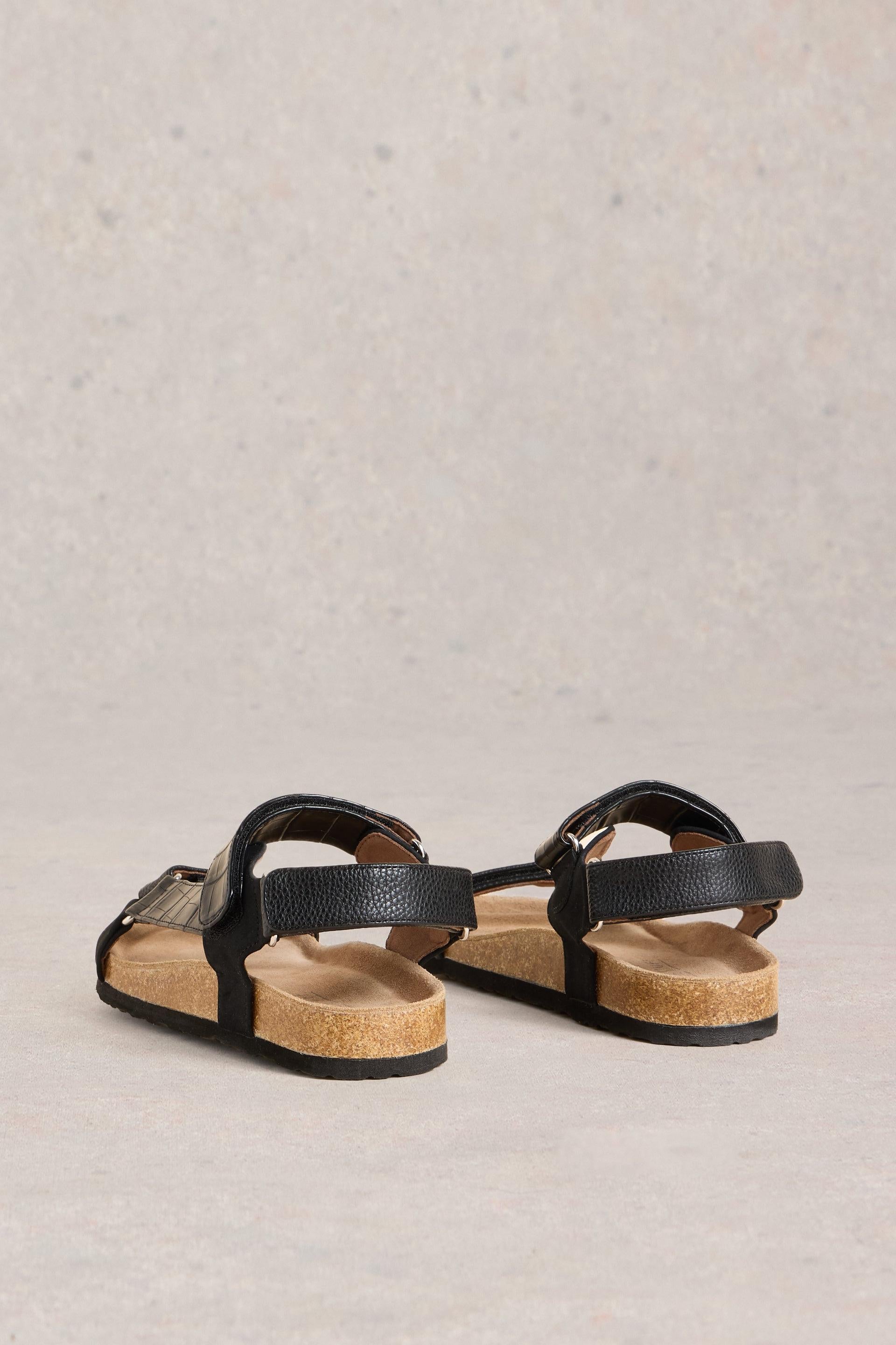 Back view of both sandals and the straps at the back.
