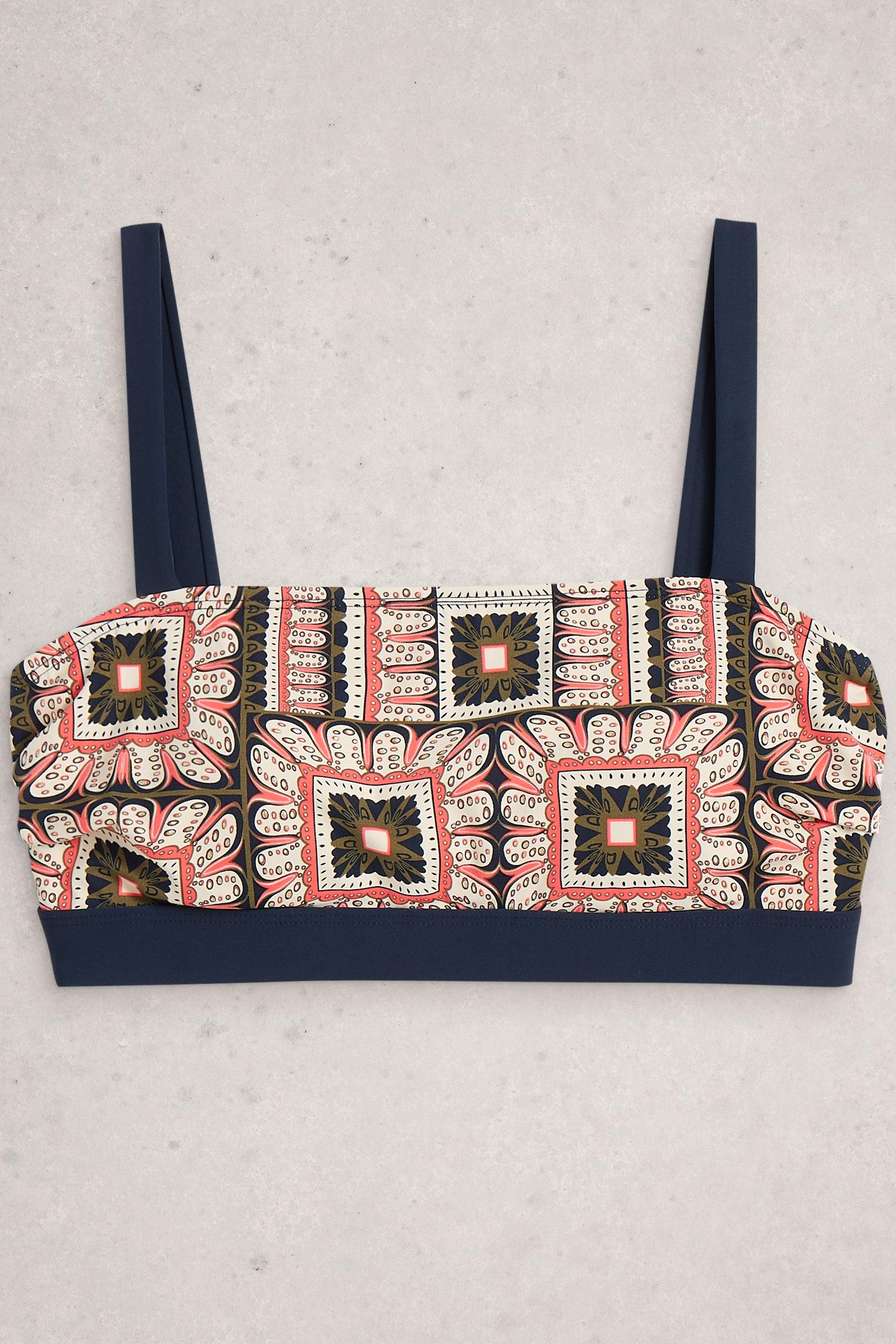 Patterned bikini top with navy straps on a light gray background
