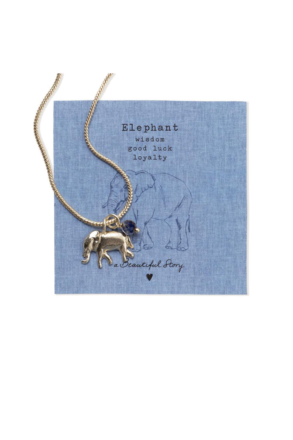 Gold elephant necklace with a blue gemstone on a blue card with text and an elephant illustration.