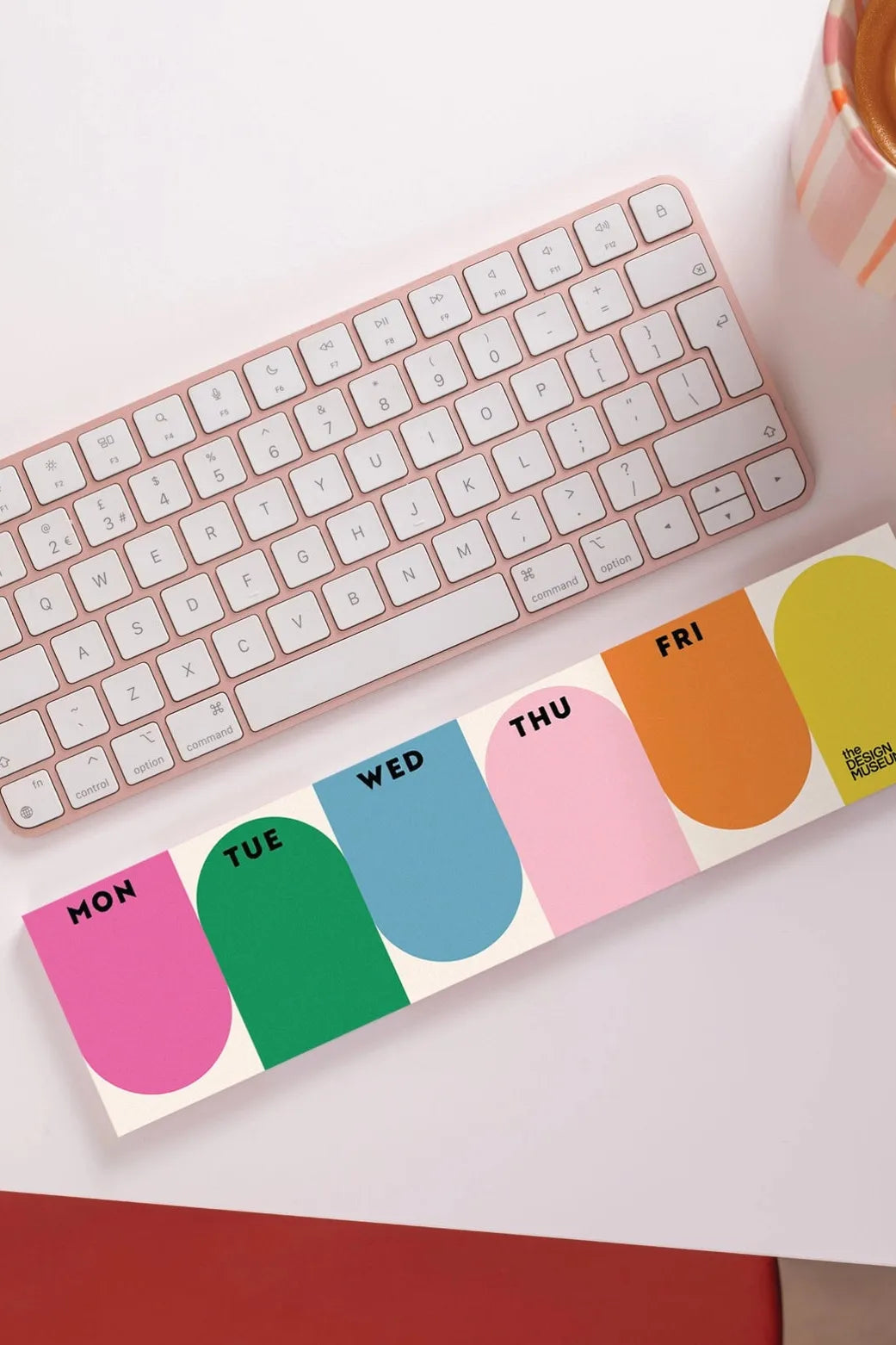 A colourful working week planner to go beside a computer keyboard.