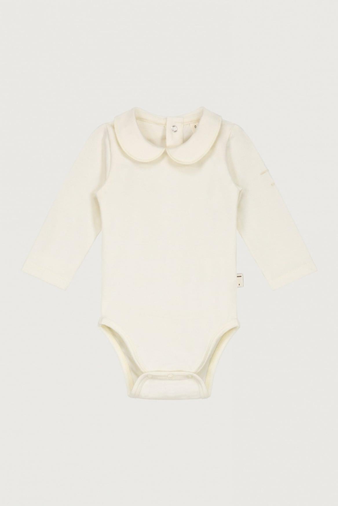 An off-white long-sleeve baby bodysuit with a Peter Pan collar, laid flat against a light gray background.