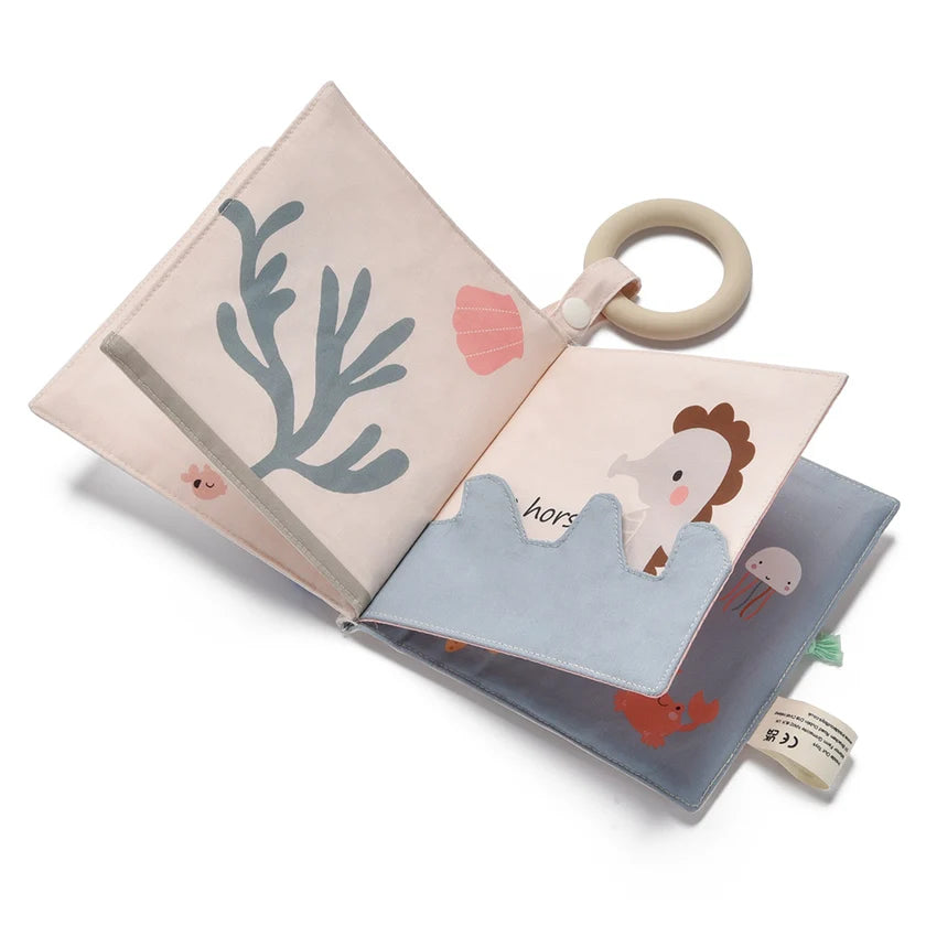 Children's soft book with illustrations of animals and a teething ring on a white background