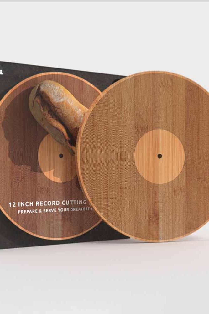 A wooden 12-inch record cutting board shown with its black branded box. The set includes a circular wooden board with a natural wood grain finish and a central light wood circle, displayed in front of a black package labeled 'pikkii' and '12 INCH RECORD CUTTING'.