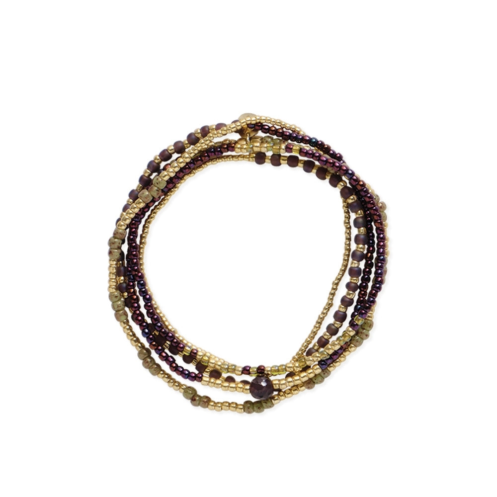 A stackable multi-strand bracelet featuring purple garnet gemstones and gold beads on a white background.