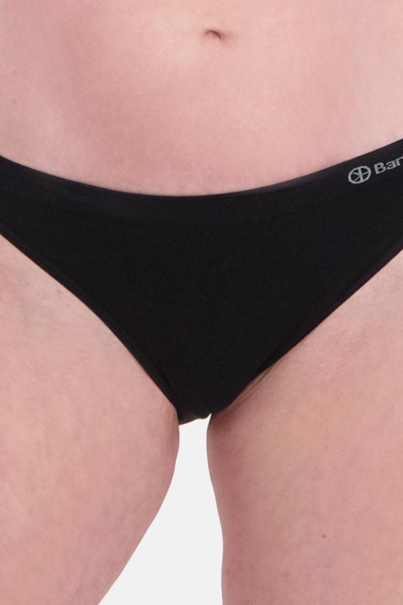 A close-up of a person wearing black Bamboo Basics seamless underwear against a white background