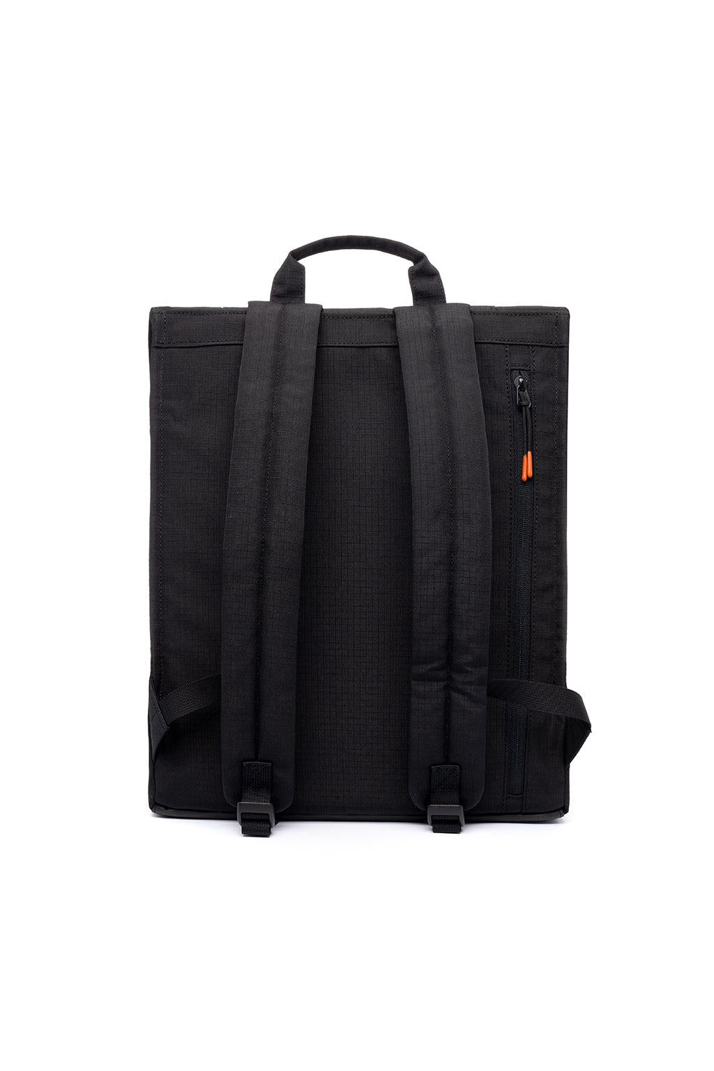 Black backpack shown from the back, featuring dual padded shoulder straps, a top carry handle, a vertical zippered pocket on the right side with a small orange accent pull, and black plastic buckle details, photographed on a white background.