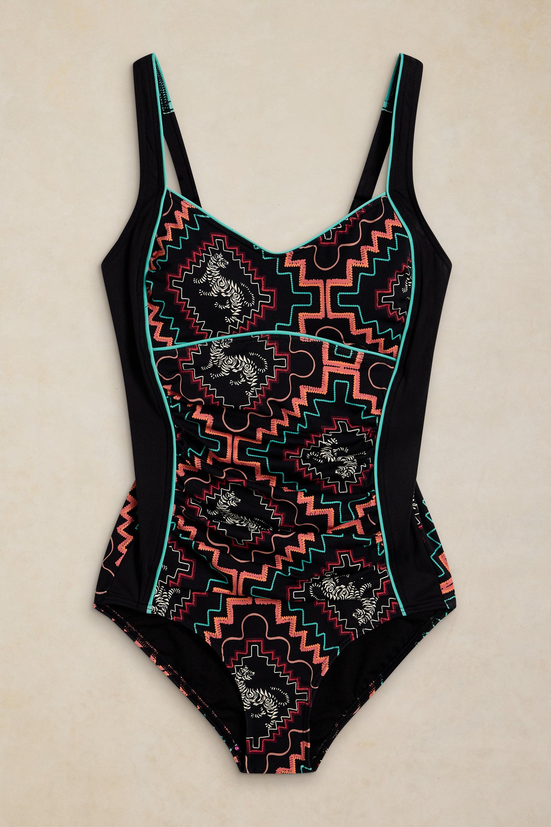 Black one-piece swimsuit featuring an orange and white geometric tribal pattern with teal trim