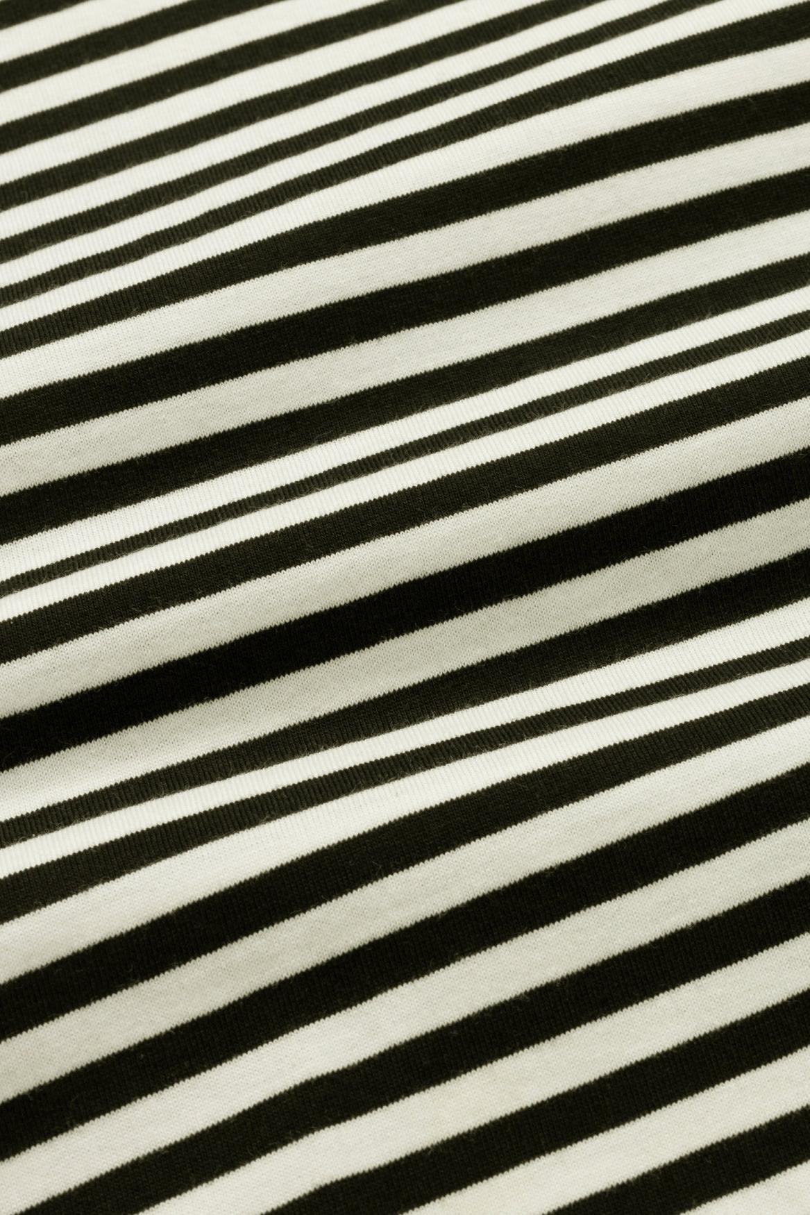 A close-up of a black and off-white striped fabric with a soft, plush texture.