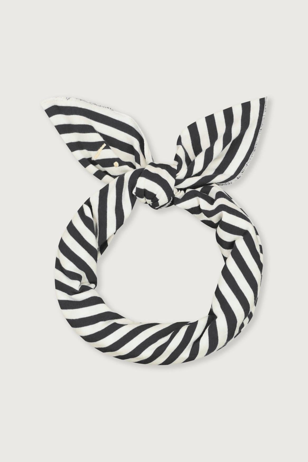 A black and white striped fabric hairband knotted into a loop, displayed against a light gray background.