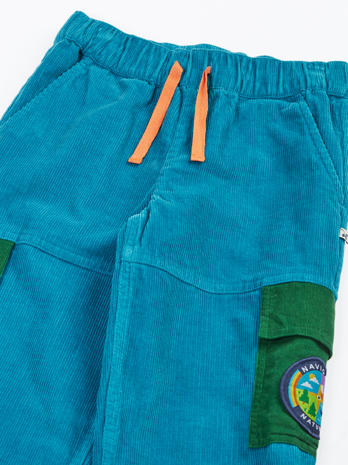 Frugi blue cord trousers with orange drawstrings and green cargo pockets made from organic cotton
