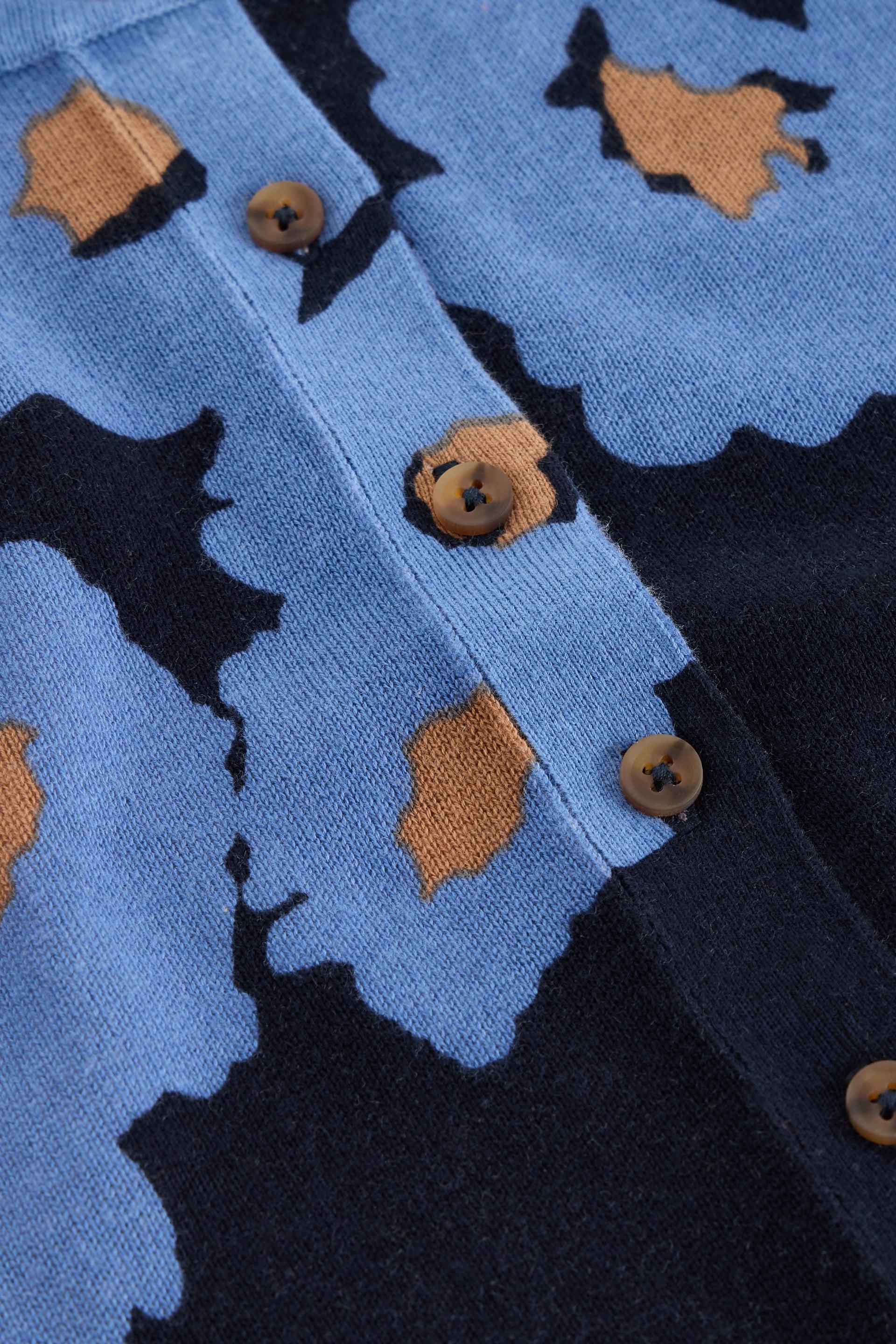 Close up of a blue floral knit cardigan made from organic cotton showing button detail