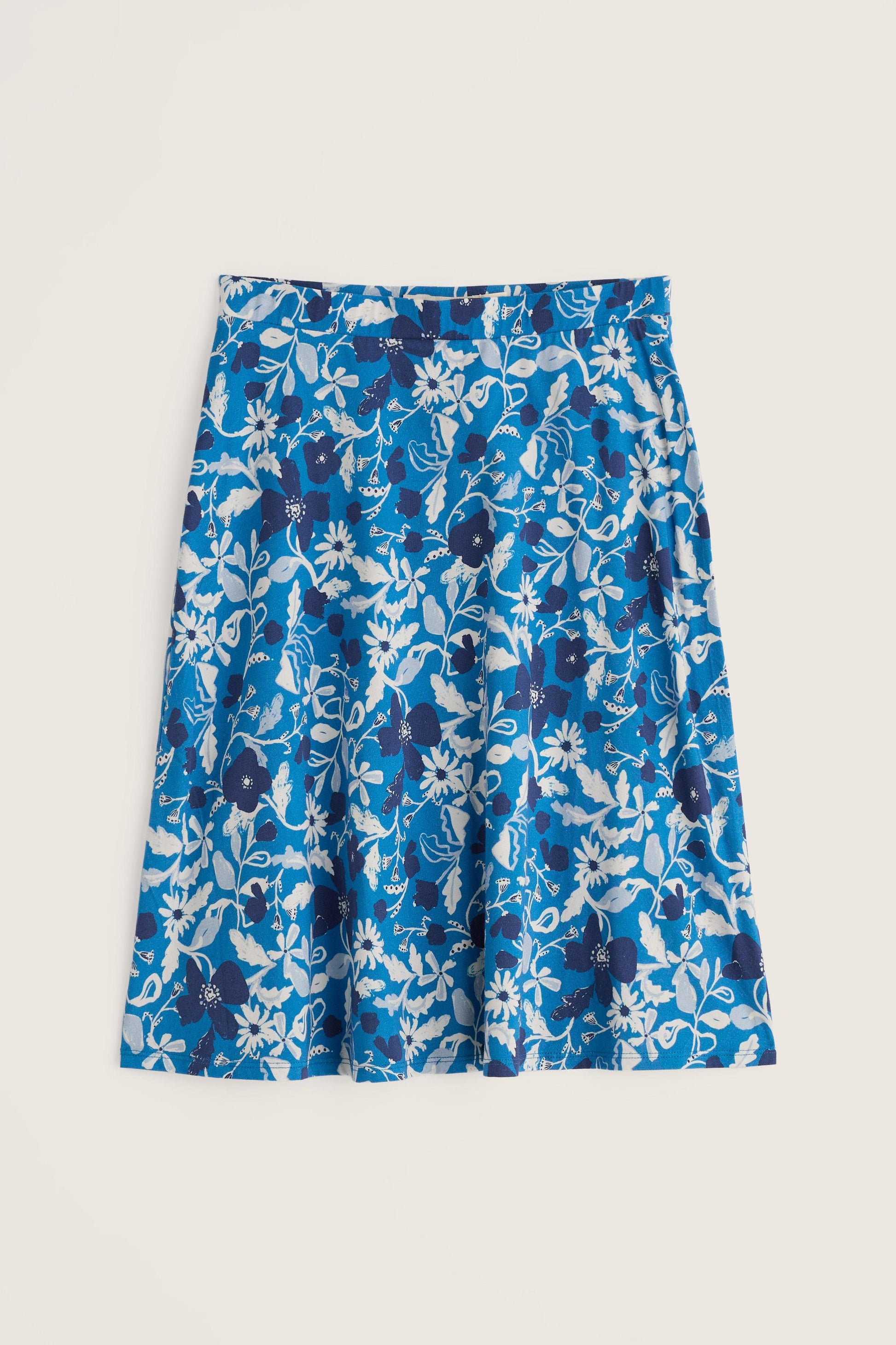 A bright blue A-line mini skirt with a white and dark blue floral pattern against a light background.