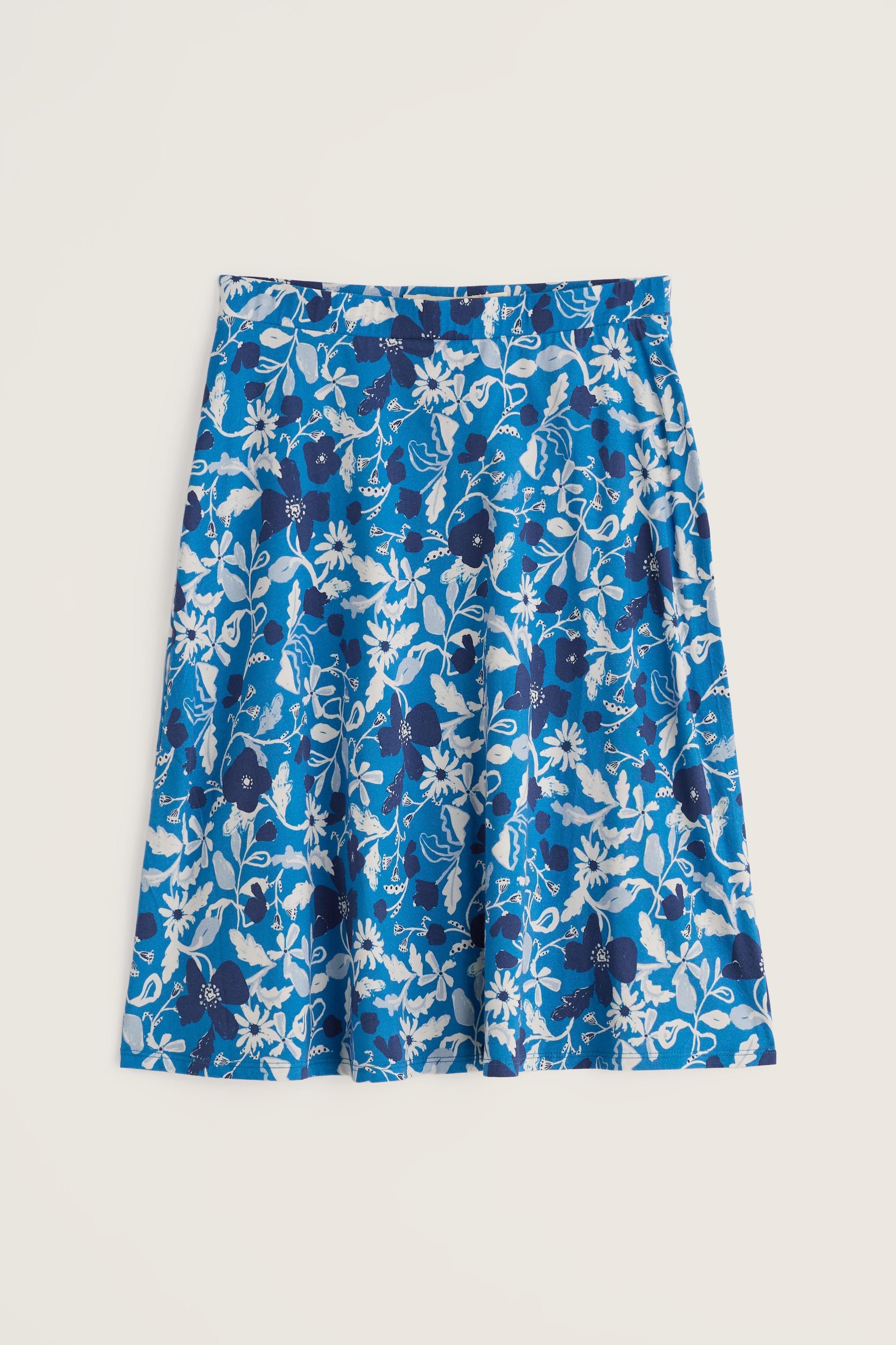 A bright blue A-line mini skirt with a white and dark blue floral pattern against a light background.