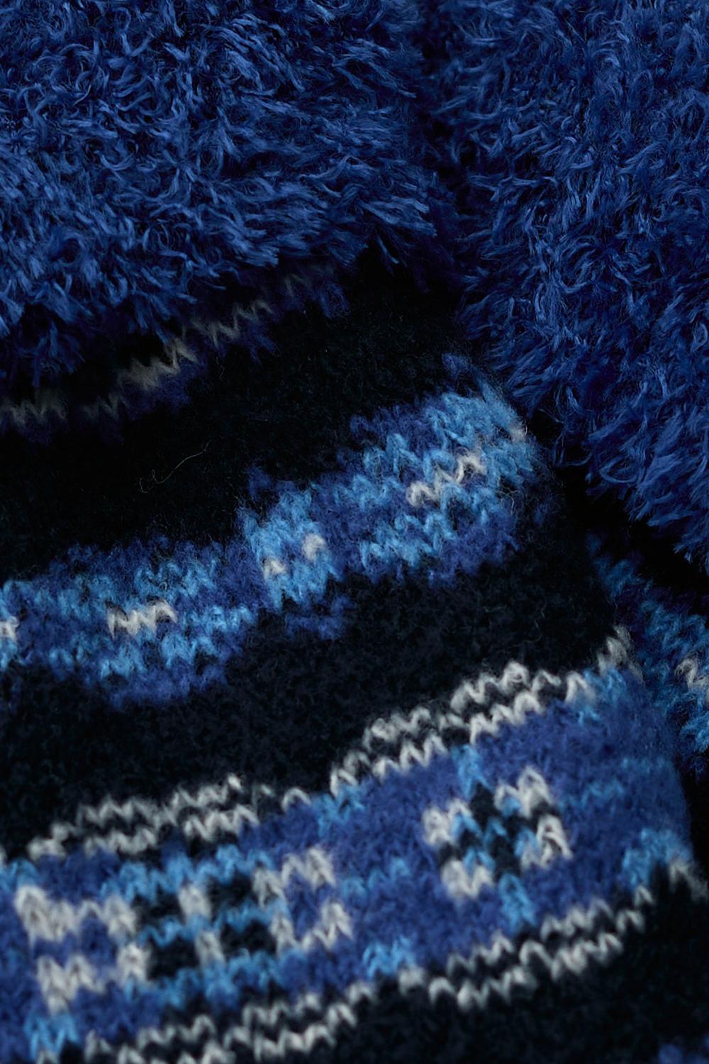 Close-up of blue fluffy cabin socks with a patterned knit design, perfect as a gift for her.
