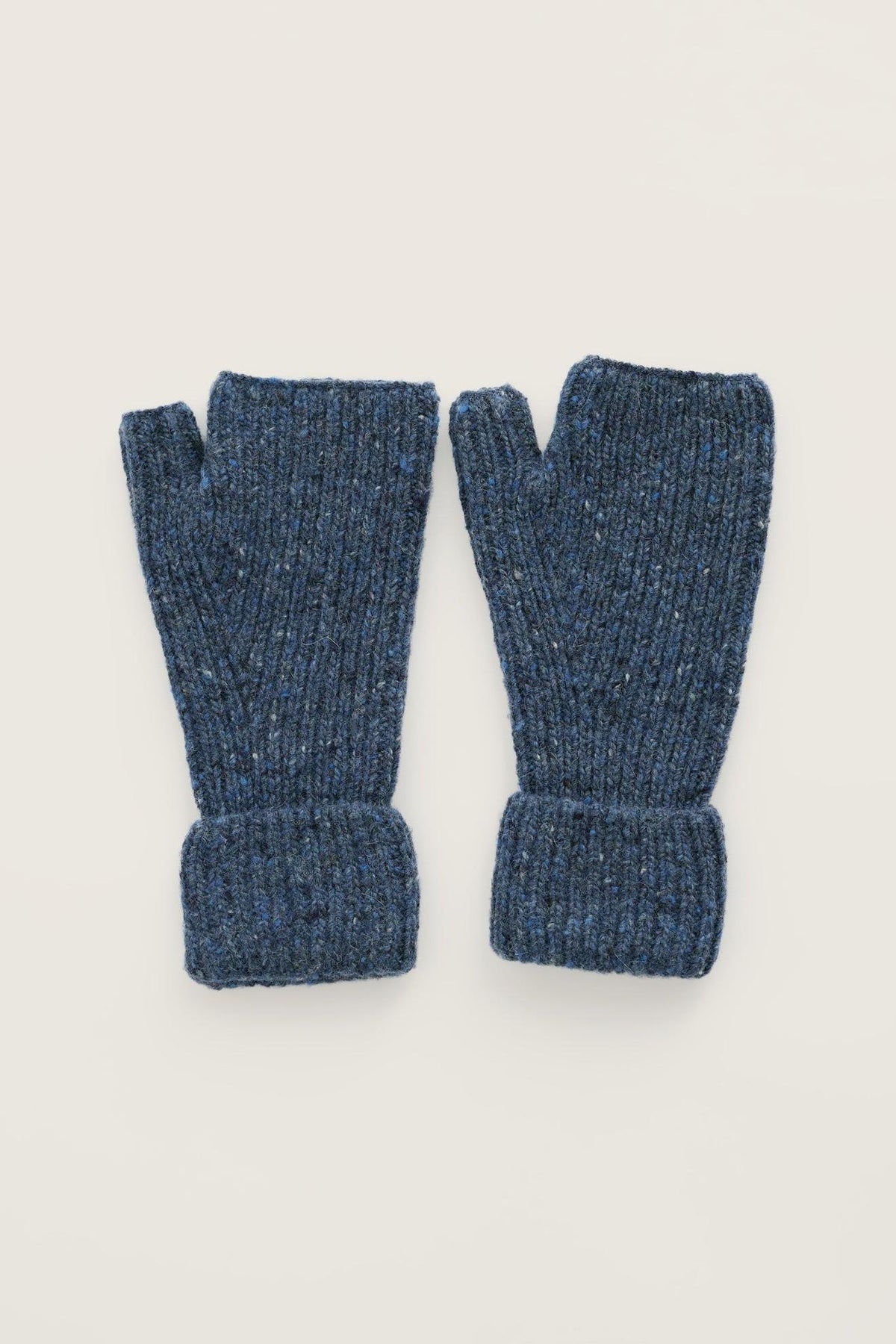 Pair of blue merino wool fingerless gloves on a light background