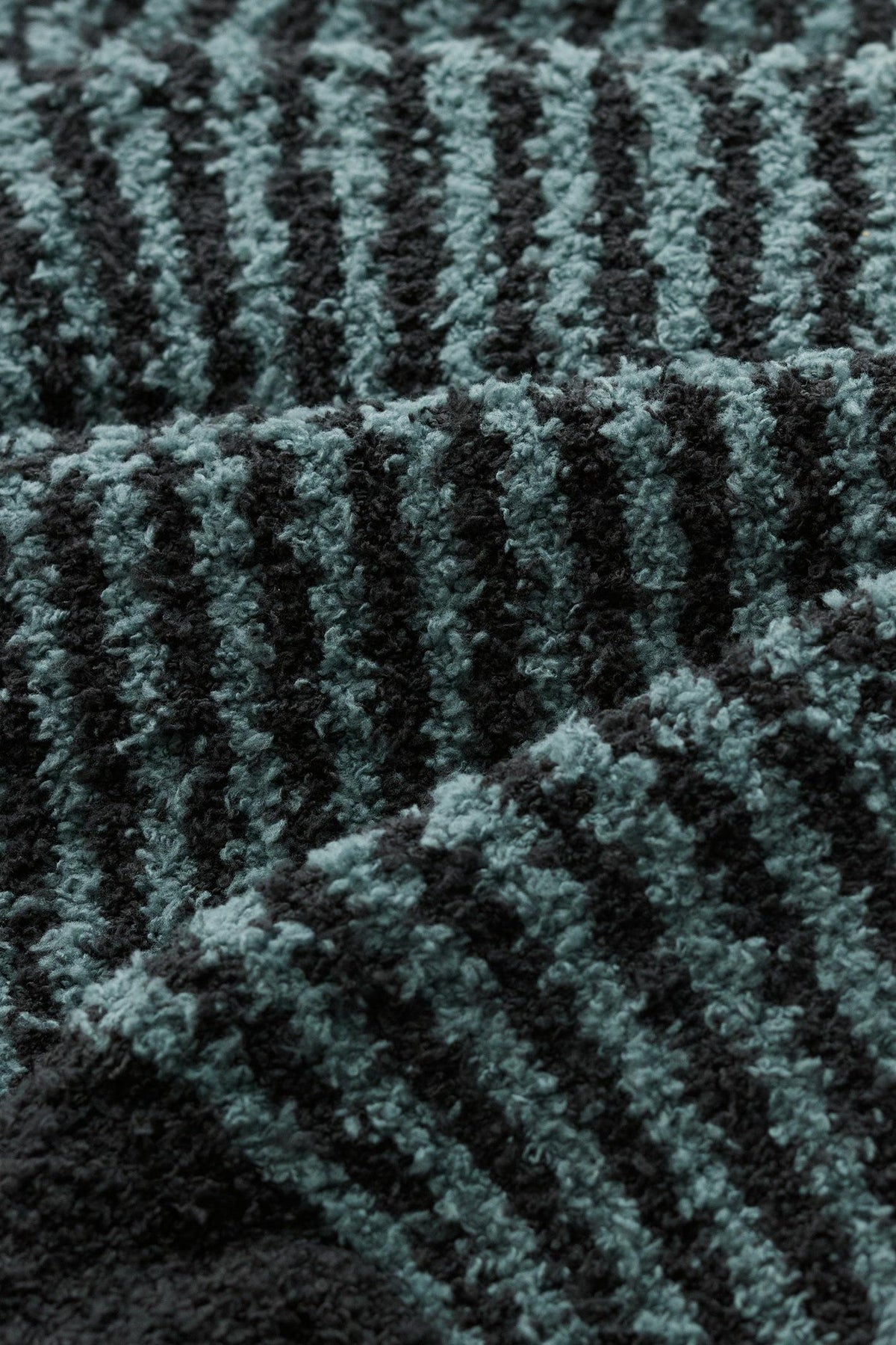 Close-up texture of Seasalt Cornwall cosy blue stripe fluffy socks fabric.