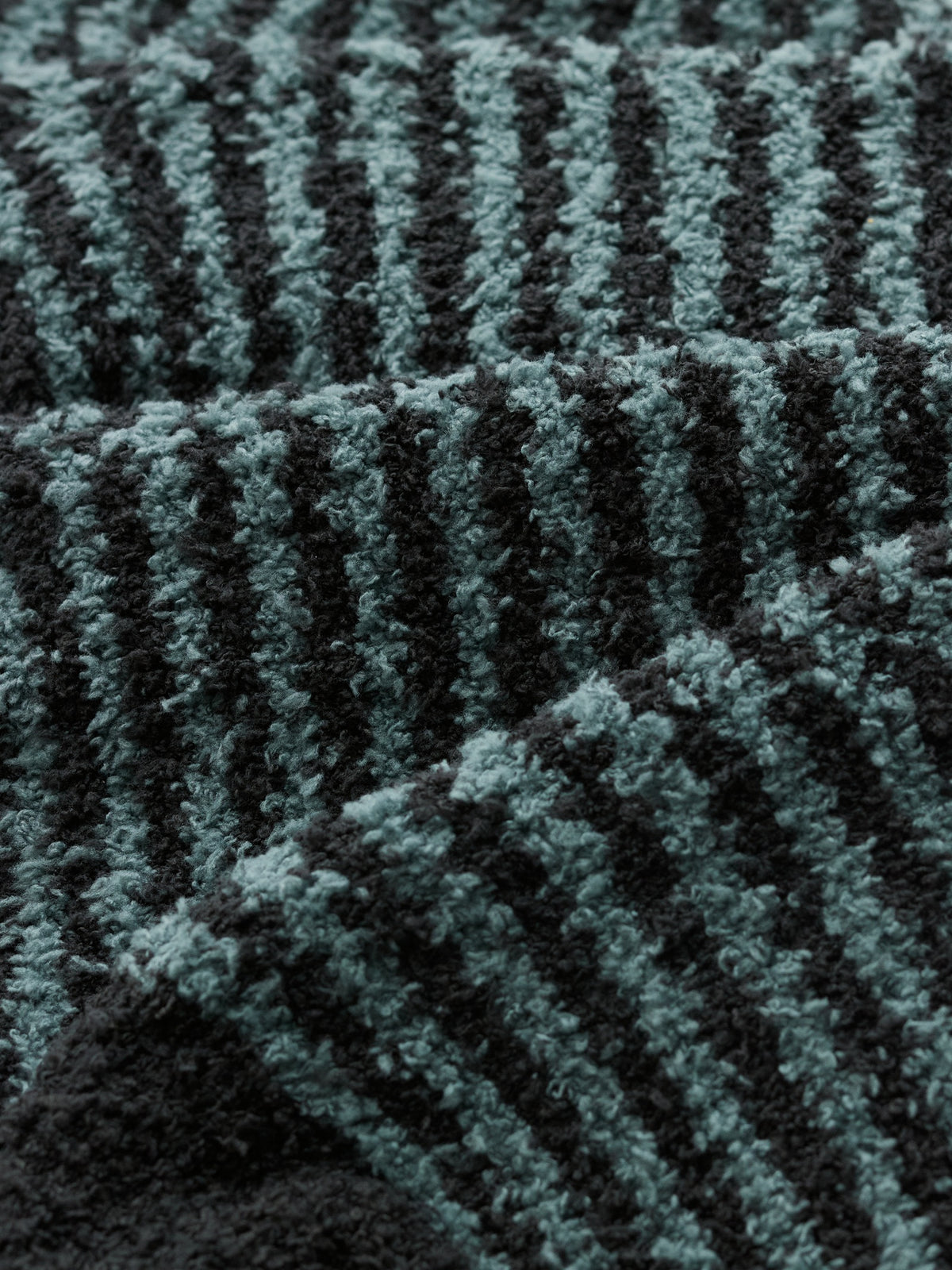 Close-up texture of Seasalt Cornwall cosy blue stripe fluffy socks fabric.