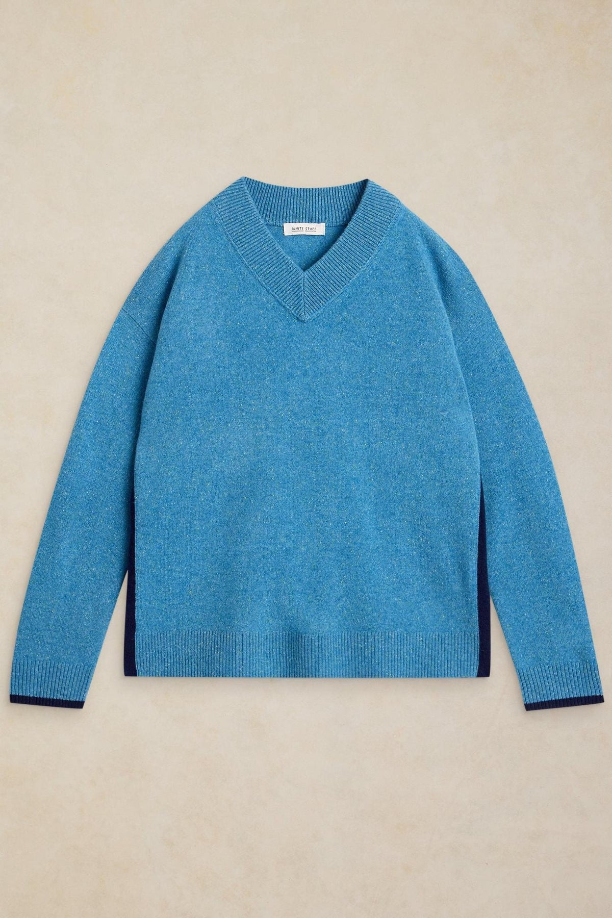 A blue V-neck knit jumper by White Stuff laid flat against a neutral background.