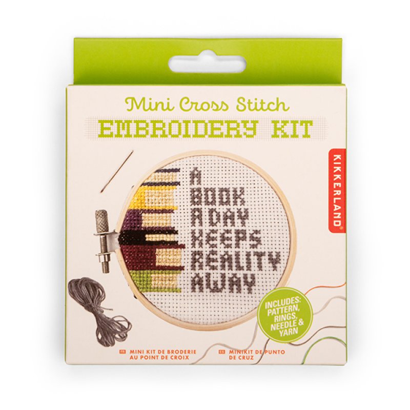 Kikkerland Mini Cross Stitch Embroidery Kit packaging with text 'A Book A Day Keeps Reality Away'.