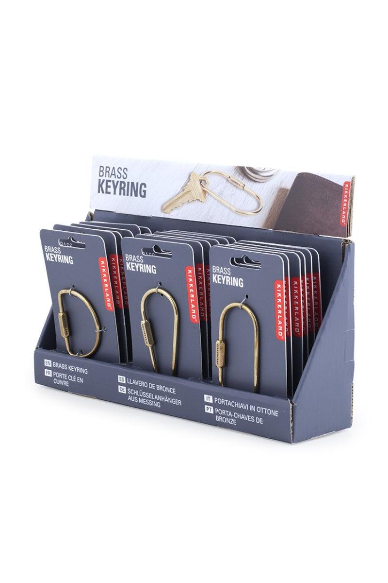 Display of brass keyrings in packaging with a white background
