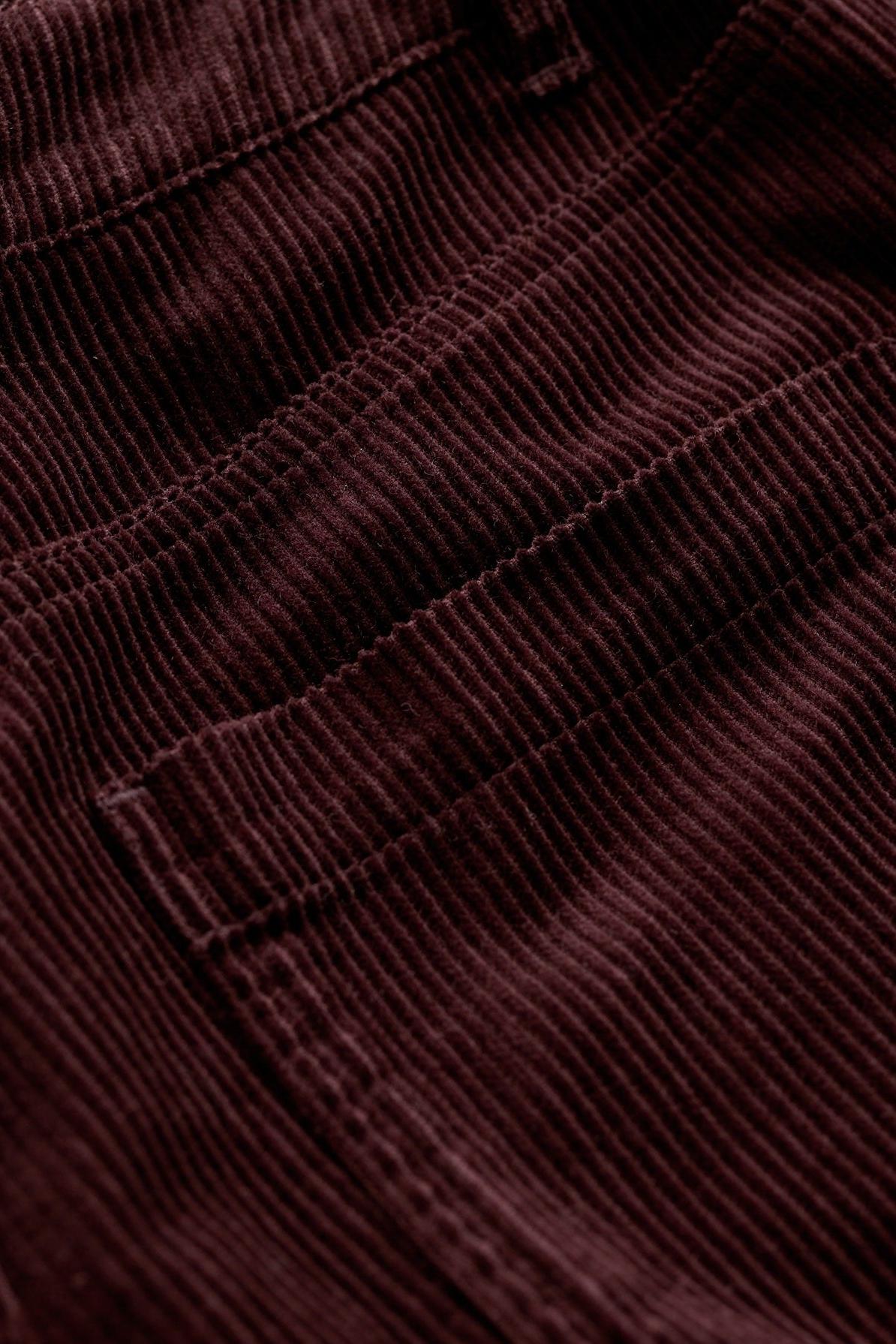 Close-up detail of dark brown corduroy fabric on Seasalt Cornwall women's trousers showing pocket stitching.