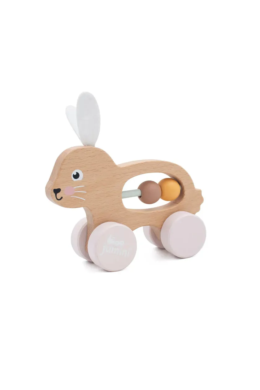 Wooden toy rabbit with wheels and beads on a white background