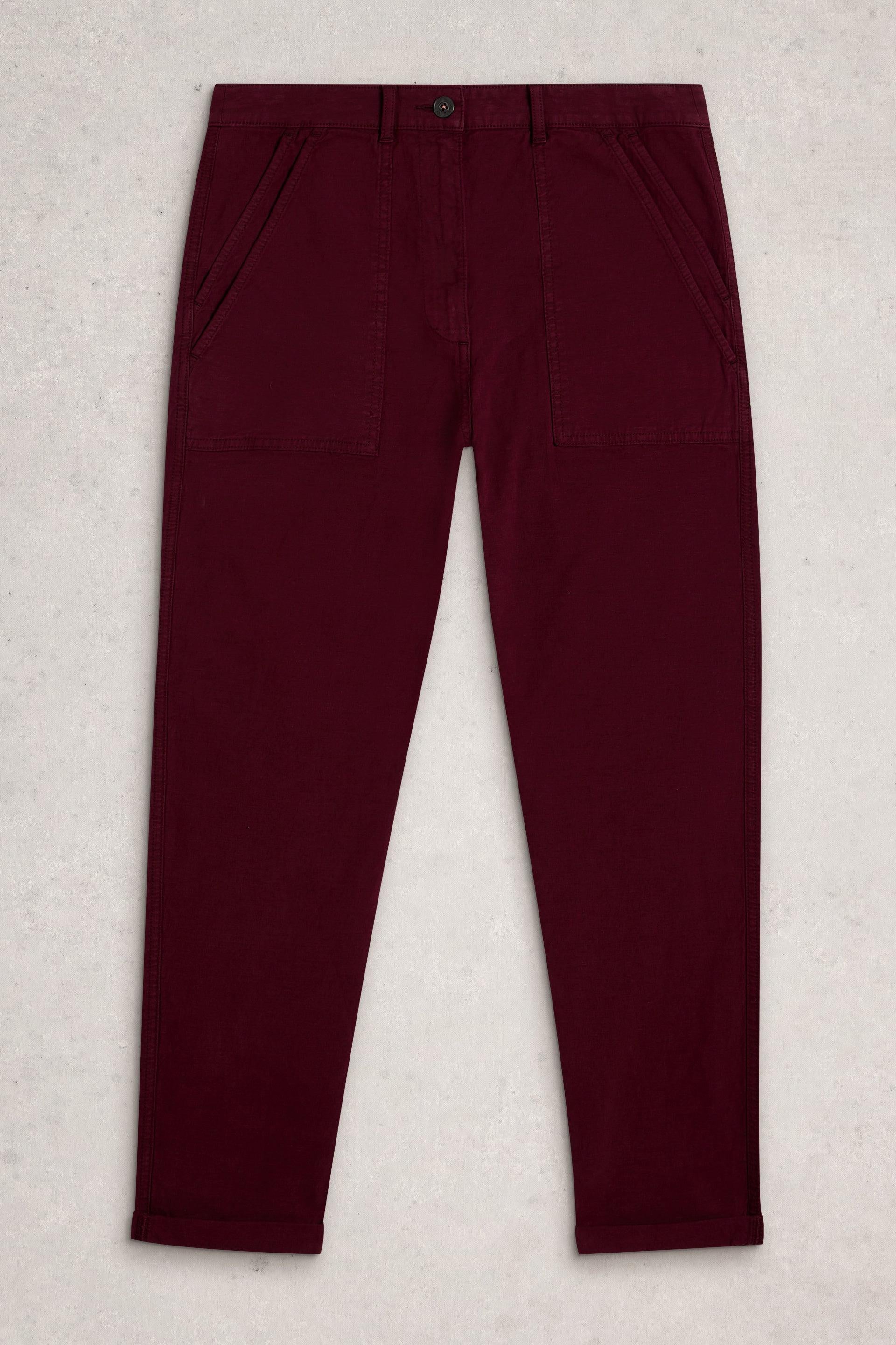 Front view of dark burgundy organic cotton utility pants with patch pockets on a neutral background.