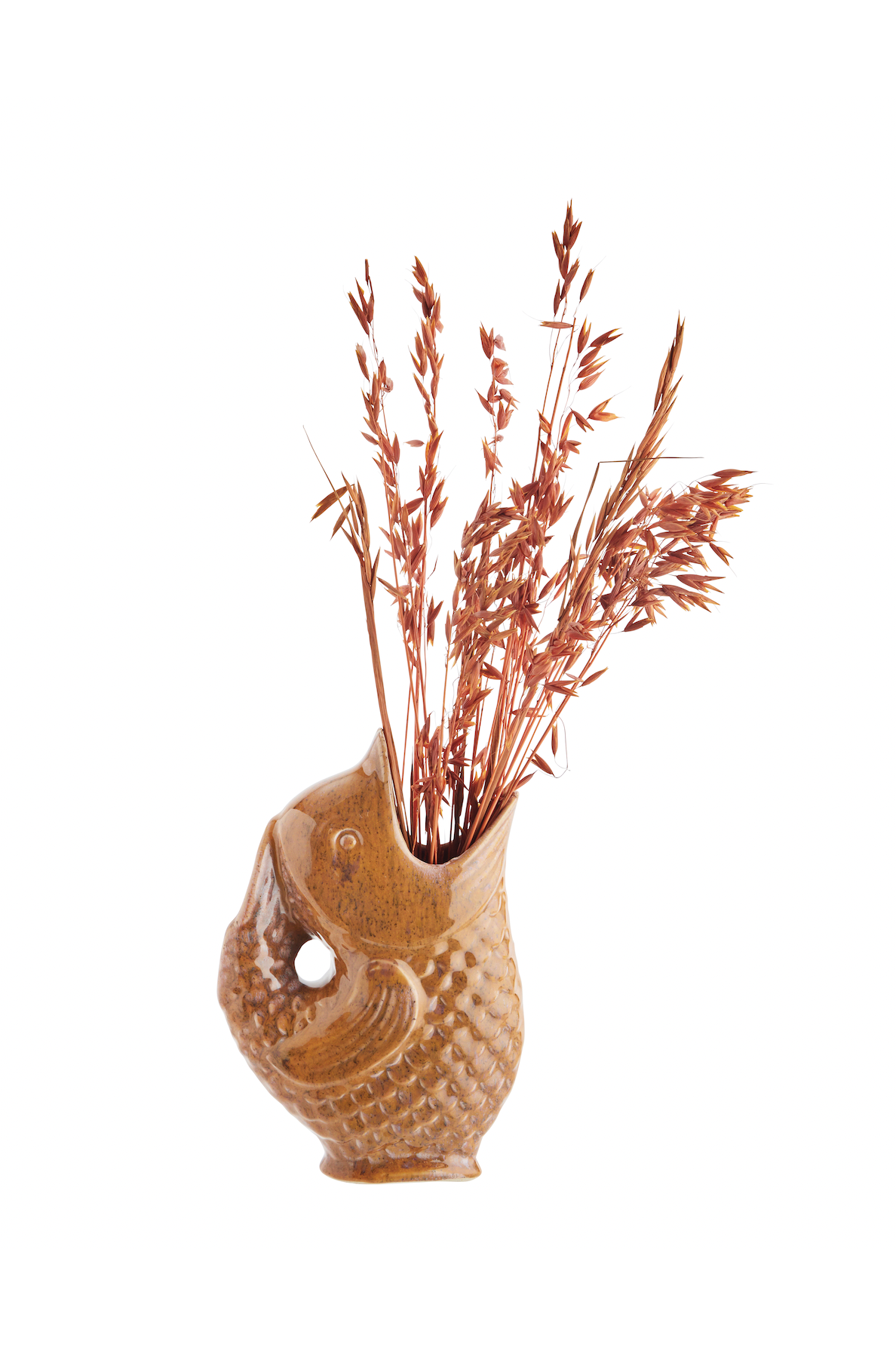 A brown ceramic fish-shaped pitcher filled with a bouquet of dried wheat stalks on a white background.