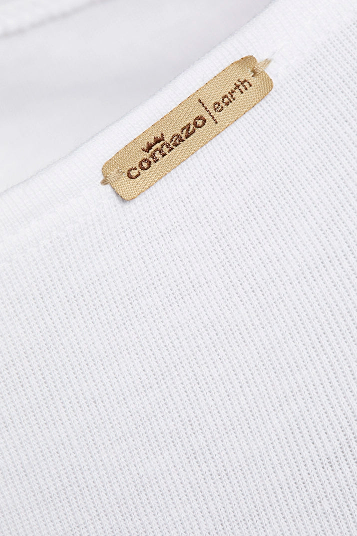 Close-up of a white textured fabric with a 'Comazo Earth' label.