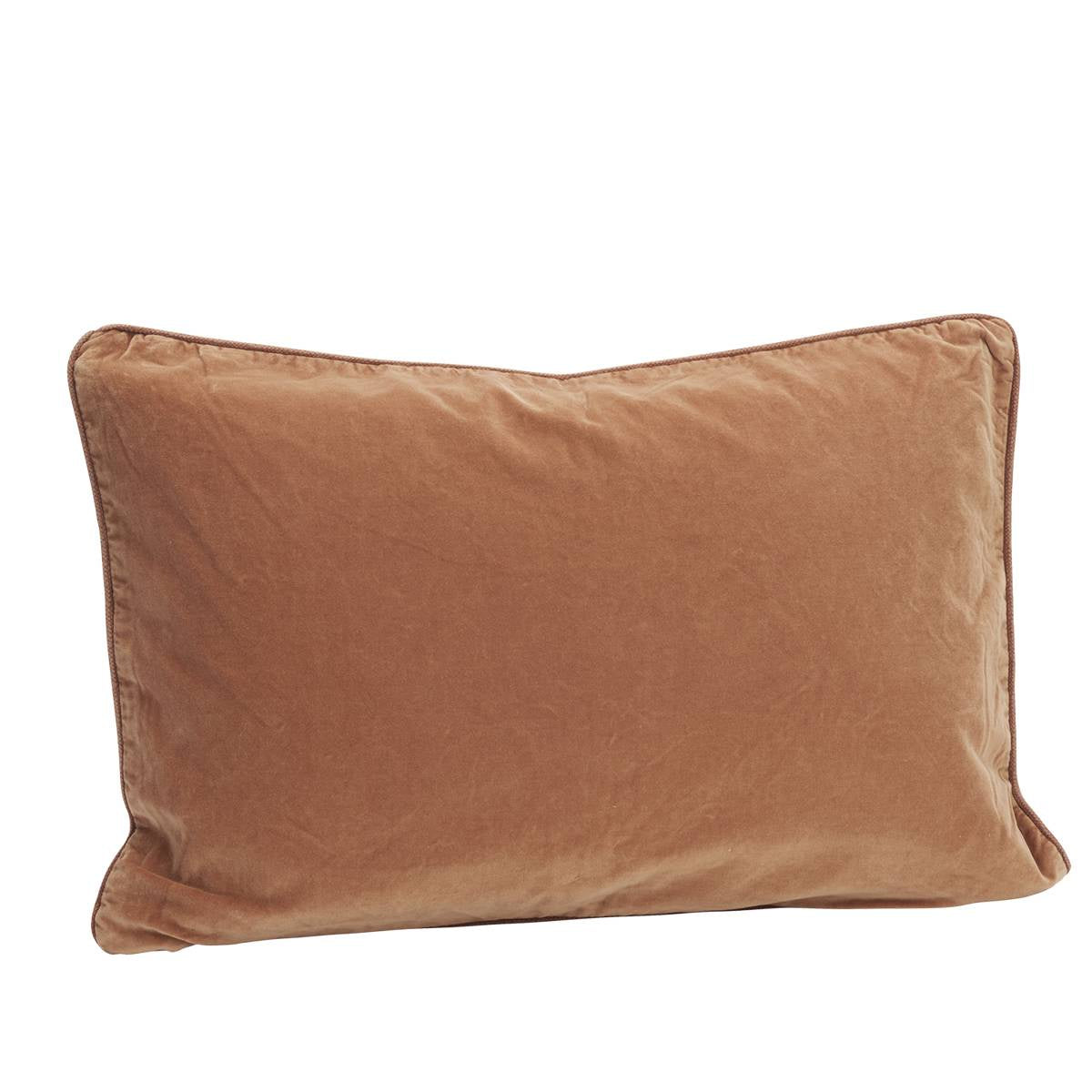 A rectangular lumbar pillow in a warm dusty pink velvet fabric, shown against a plain white background.