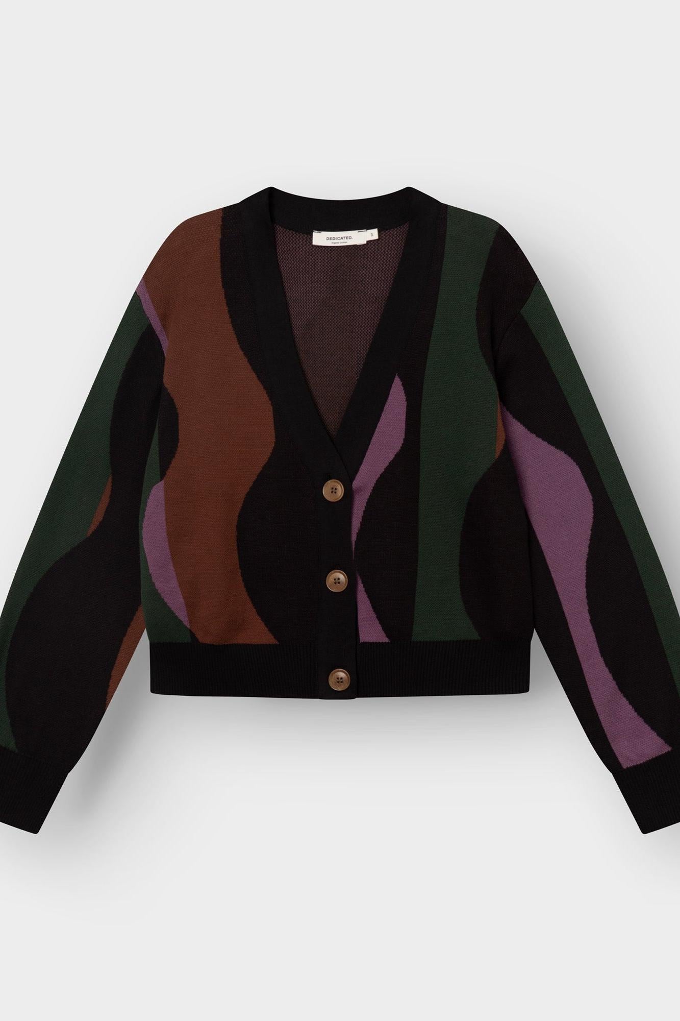 A cropped cardigan sweater with a black base and abstract wavy color-blocked patterns in brown, green, and purple, featuring three brown buttons on a light gray background.