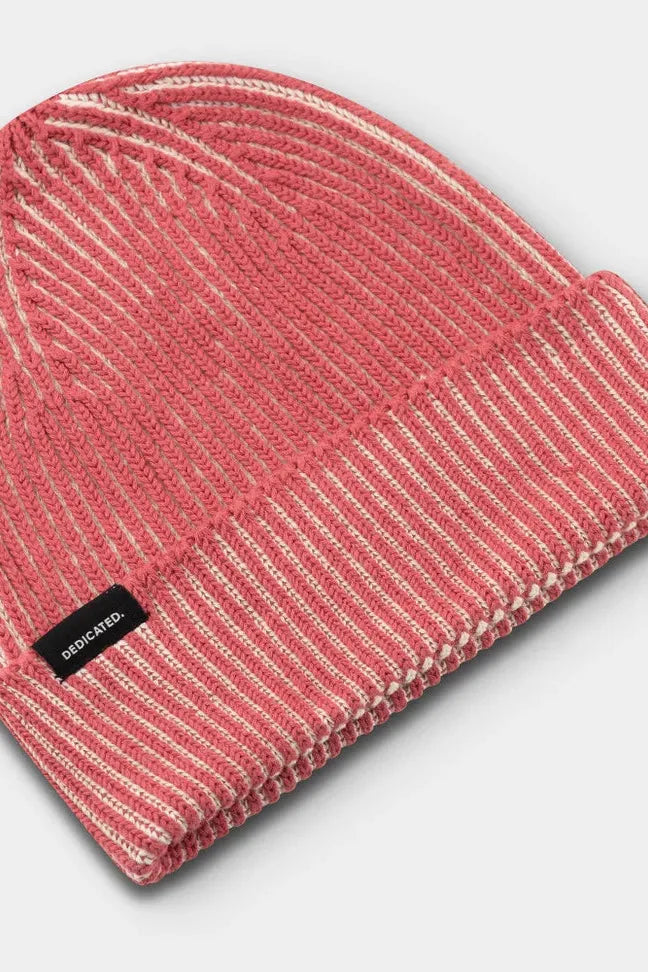 A ribbed Dedicated cotton beanie in a red and white marled knit texture with a small black brand label.