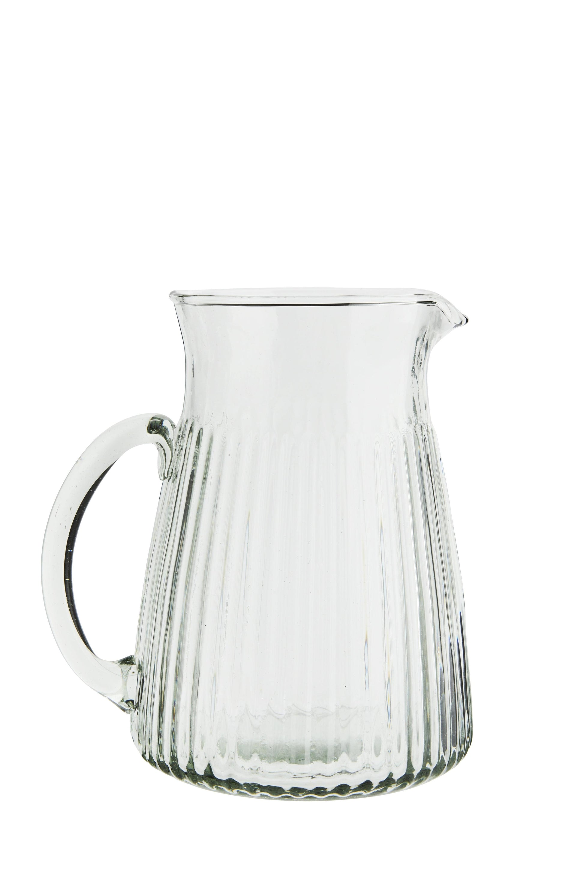 Clear glass pitcher with ribbed design on a white background