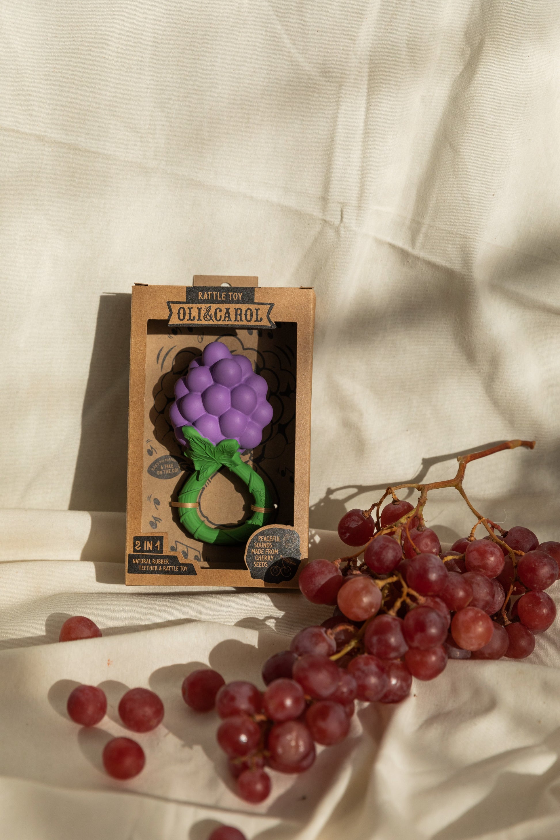Handcrafted natural rubber grape baby rattle and teether, non-toxic, mold-free, and easy for tiny hands to grasp.