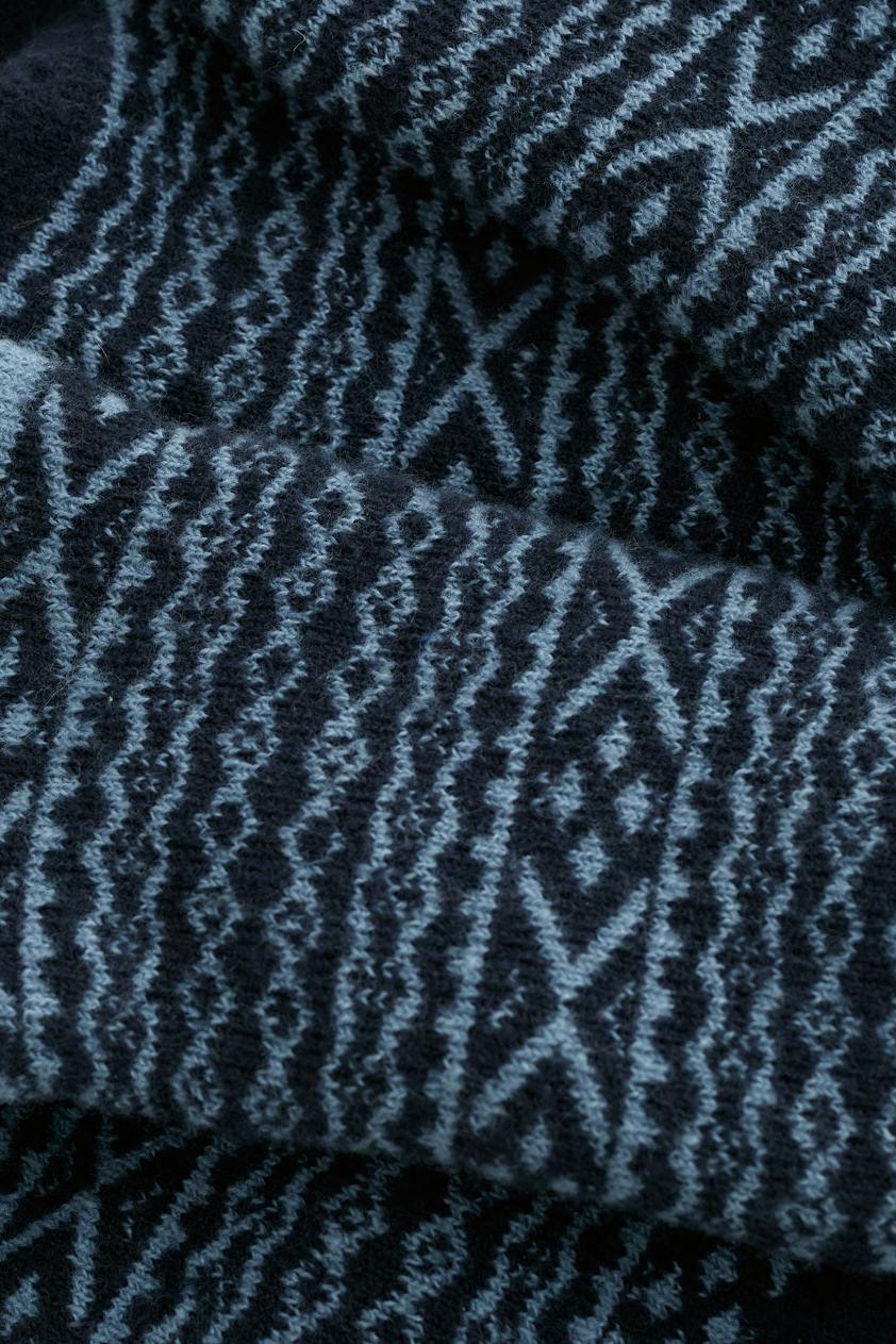 Close-up of navy and light blue patterned fabric from Seasalt Cornwall cosy cabin socks.