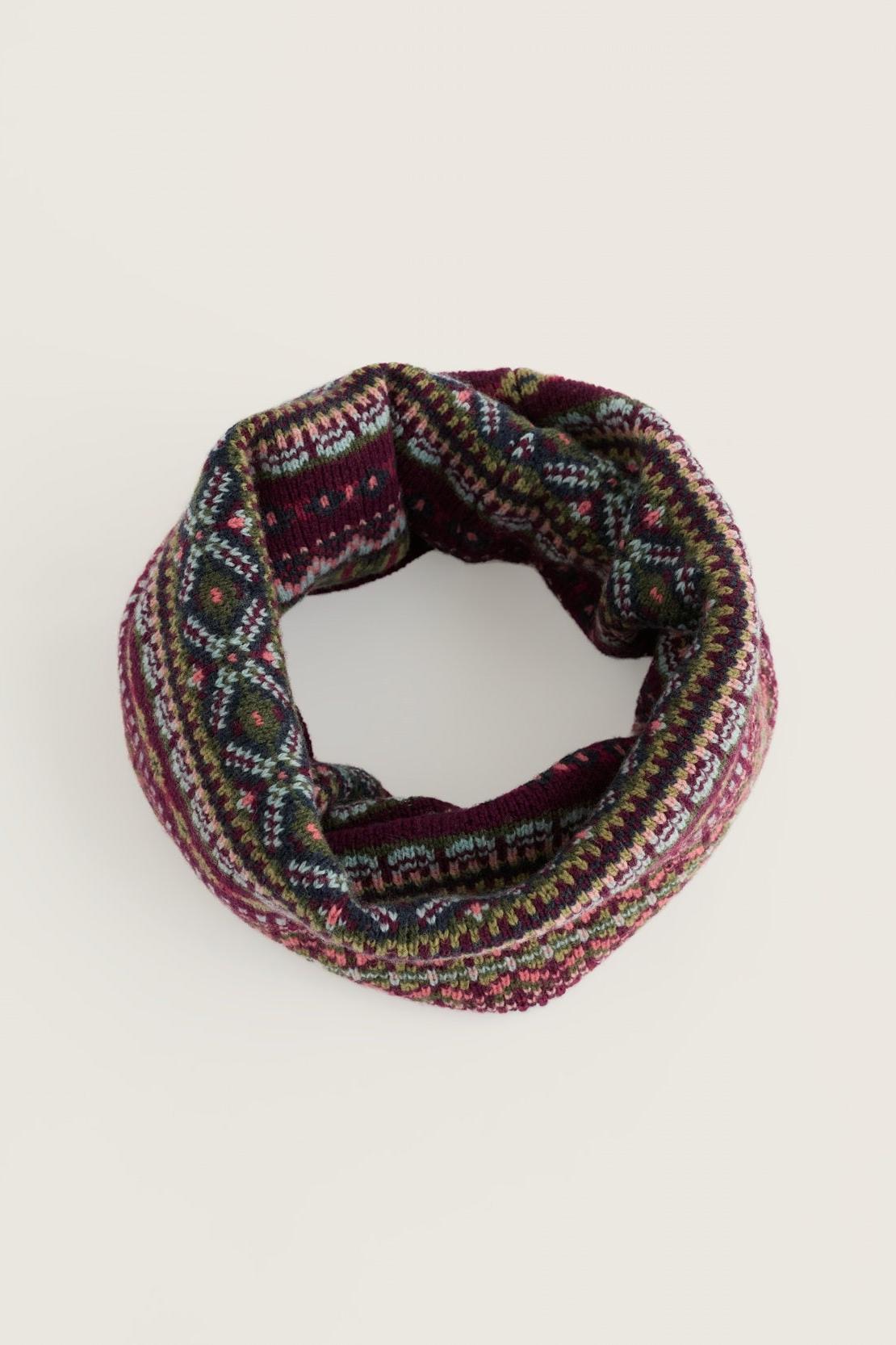 A cozy, patterned wool snood scarf with a festive Fair Isle design against a plain light background.