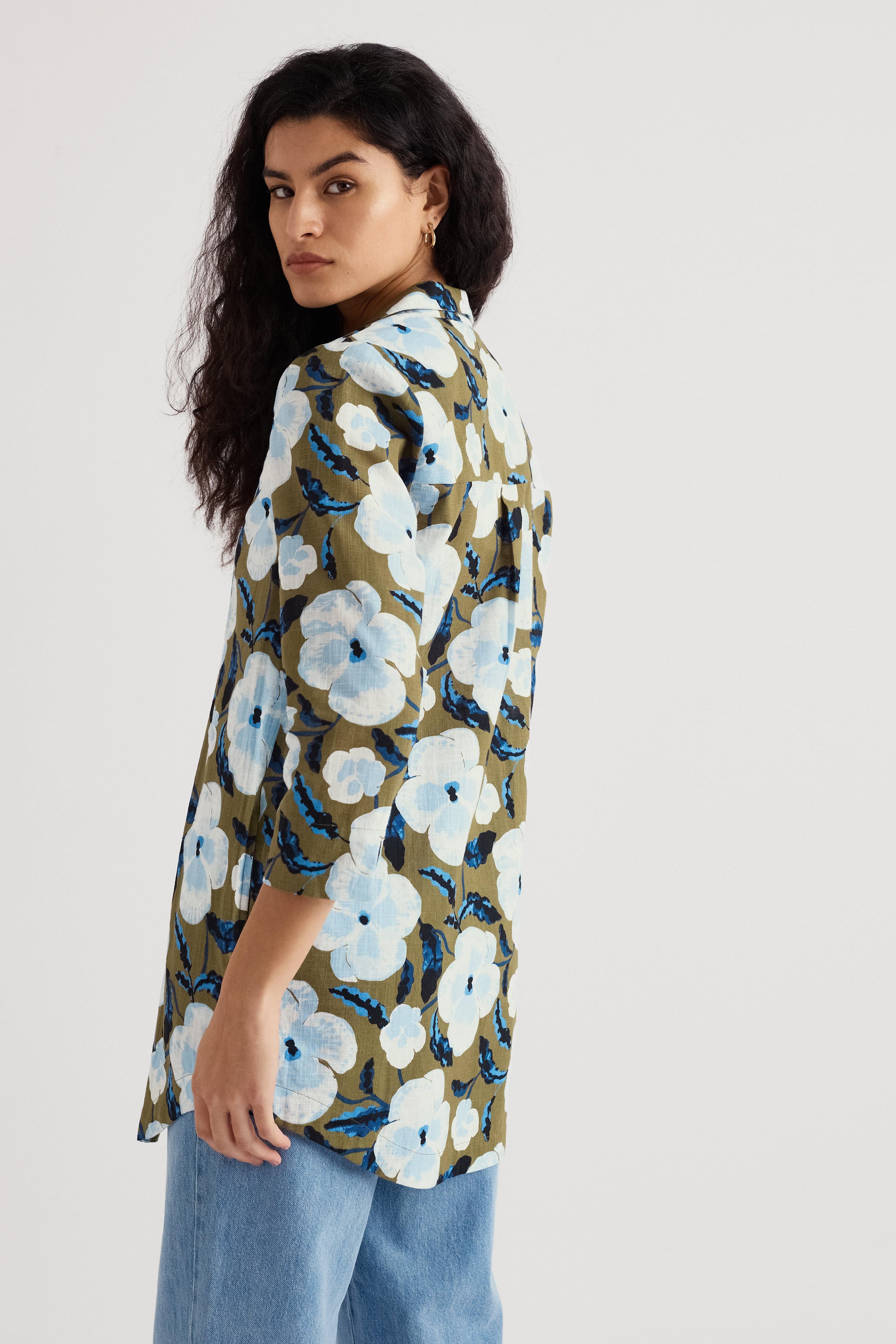 Woman wearing a floral organic cotton shirt with a white background