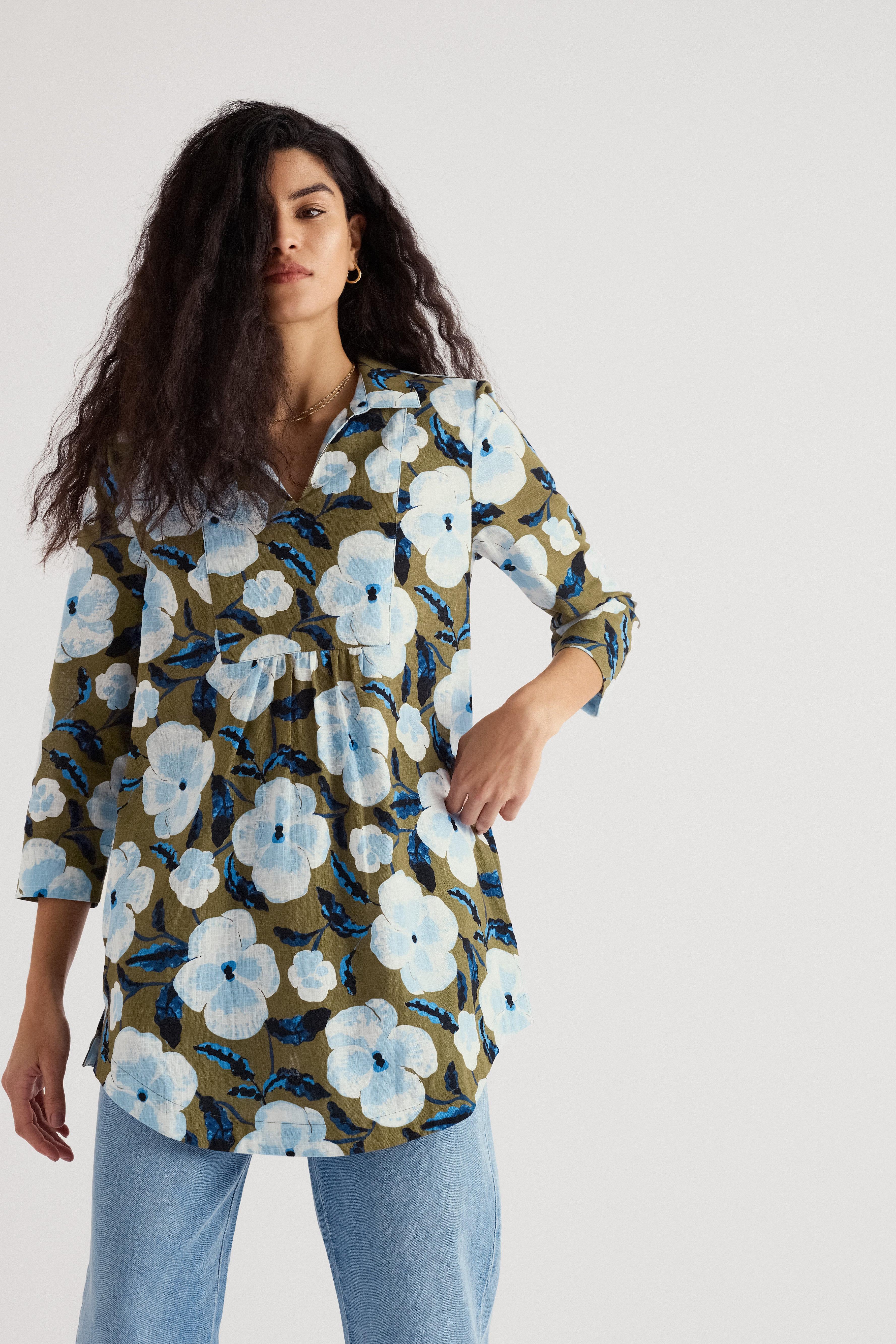 Woman wearing a floral patterned shirt with a plain background