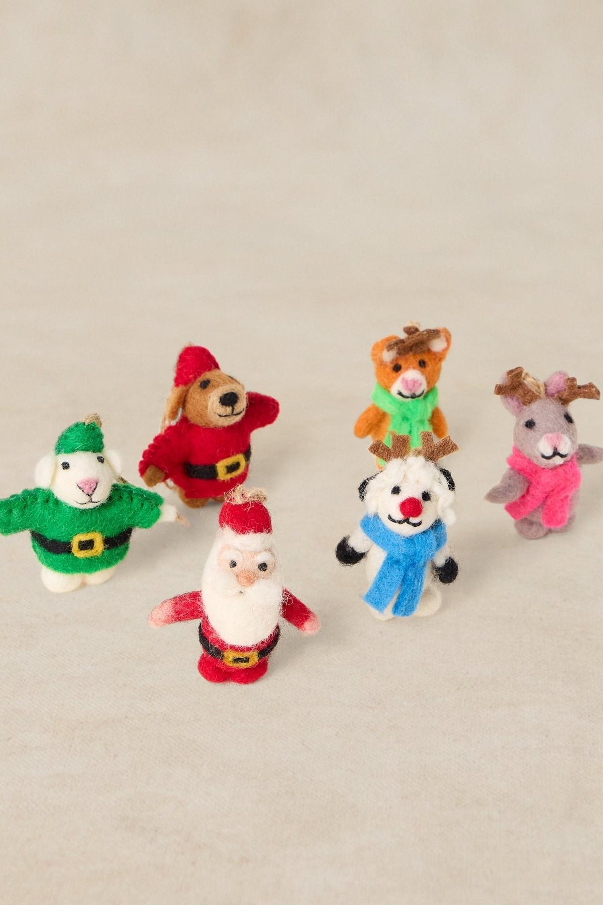 Set of handcrafted felt wool Christmas tree decorations including Santa, a snowman, and reindeer figures.