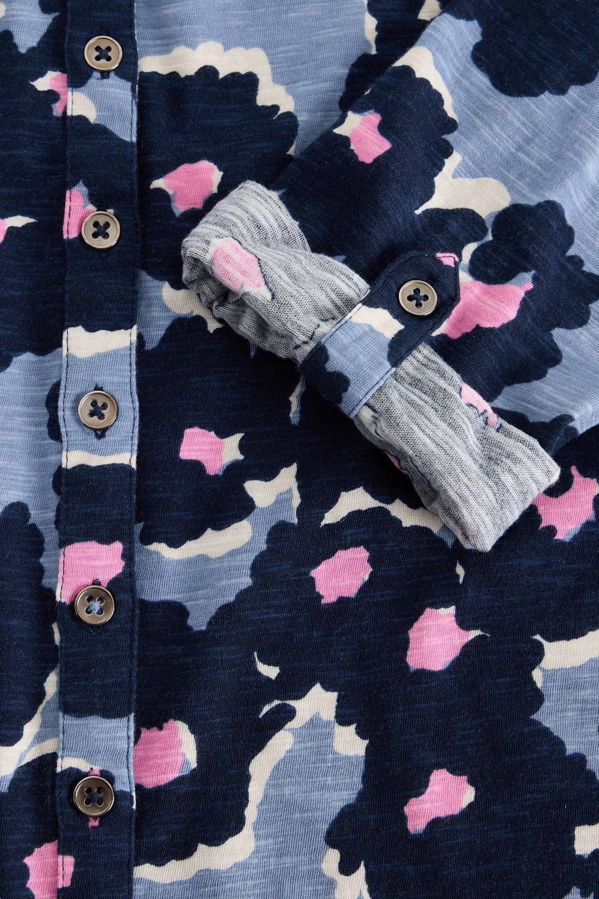 Close up of a blue and pink floral patterned shirt with buttons from White Stuff.
