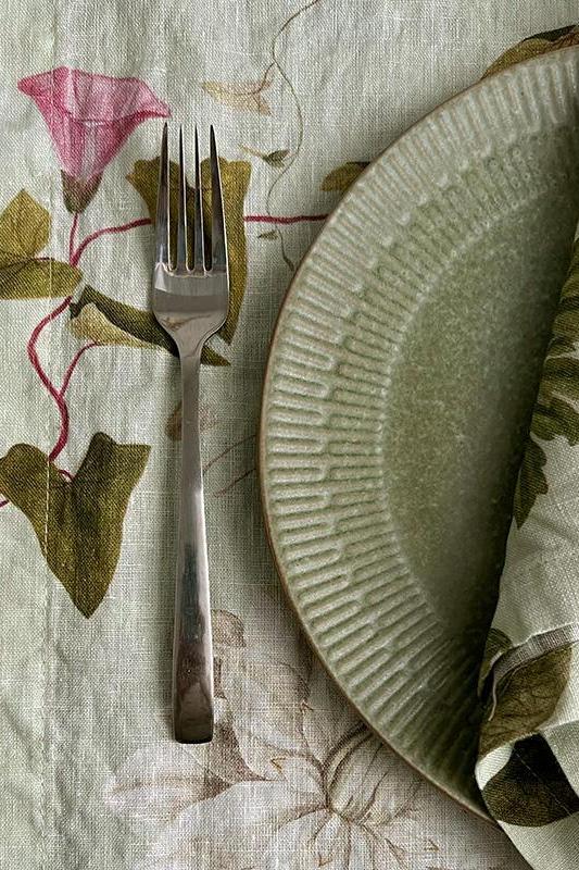 Plated dish with fork on a floral tablecloth