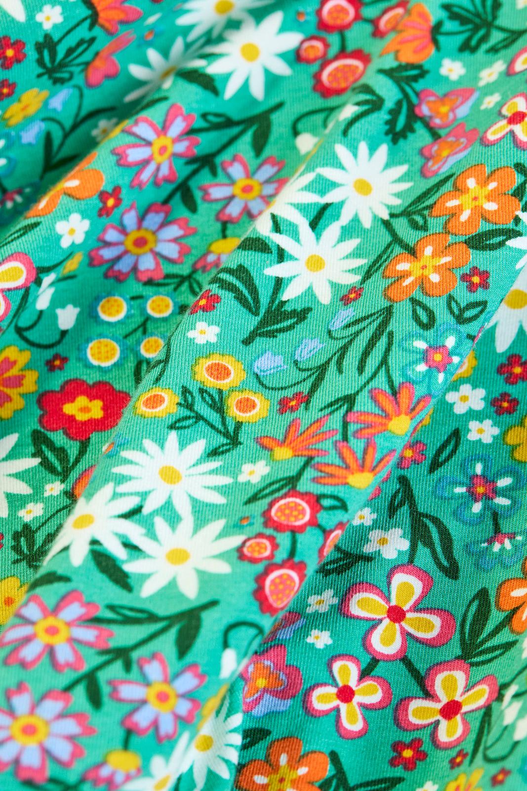 Frugi organic cotton green long sleeve girls dress with a colorful floral print pattern.